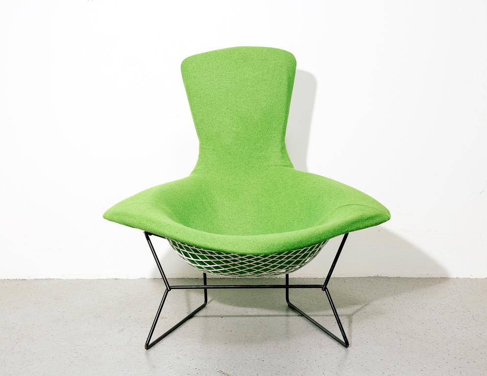 Bird chair designed by Harry Bertoia for Knoll, 1950s. White wire frame on black rod base. Newly upholstered in lime green Maharam wool.