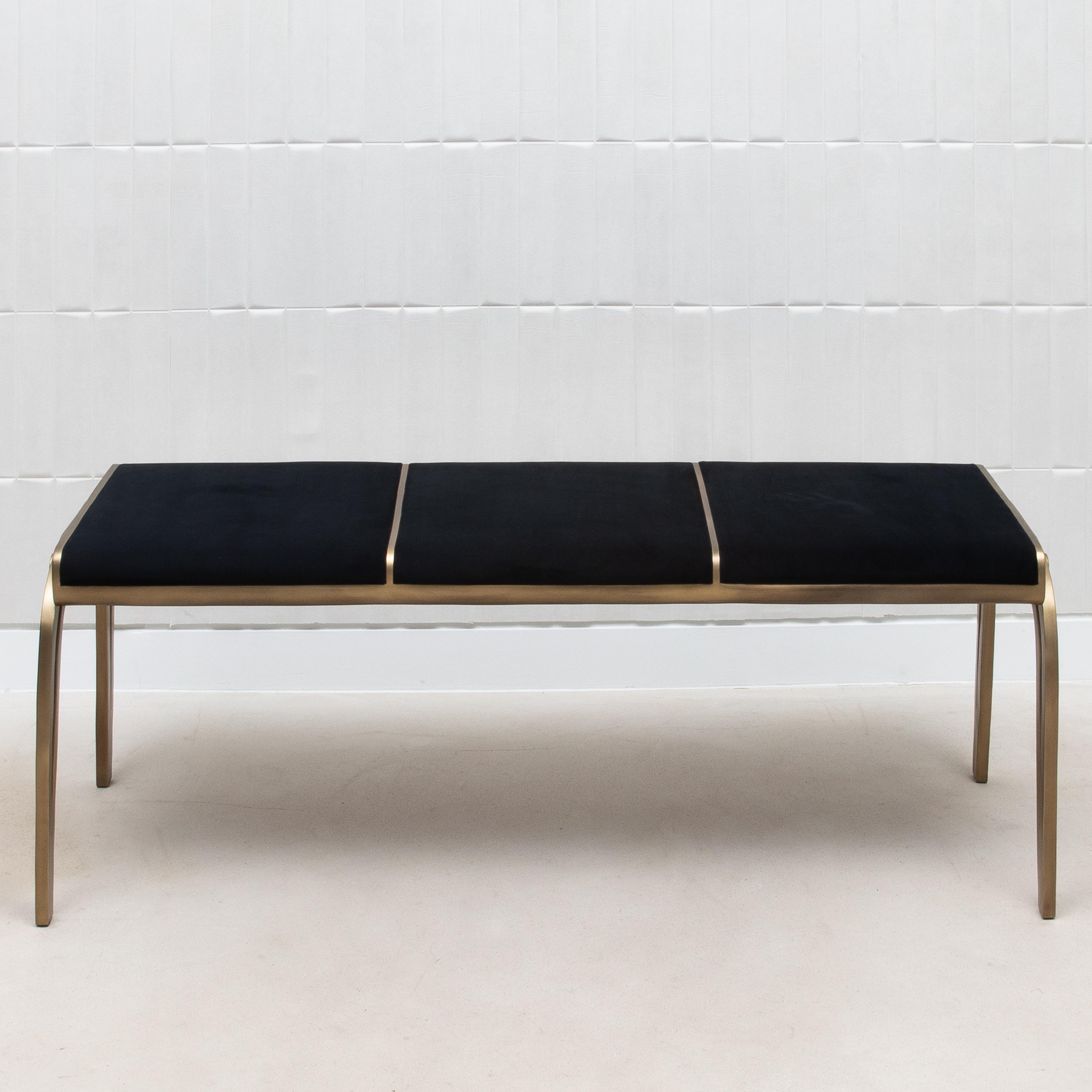 The Victoria Bench by R&Y Augousti is a luxurious blend of rich black velvet and warm bronze patina brass, meticulously hand-crafted to perfection. The sumptuous black velvet upholstery exudes elegance and sophistication, creating a plush surface