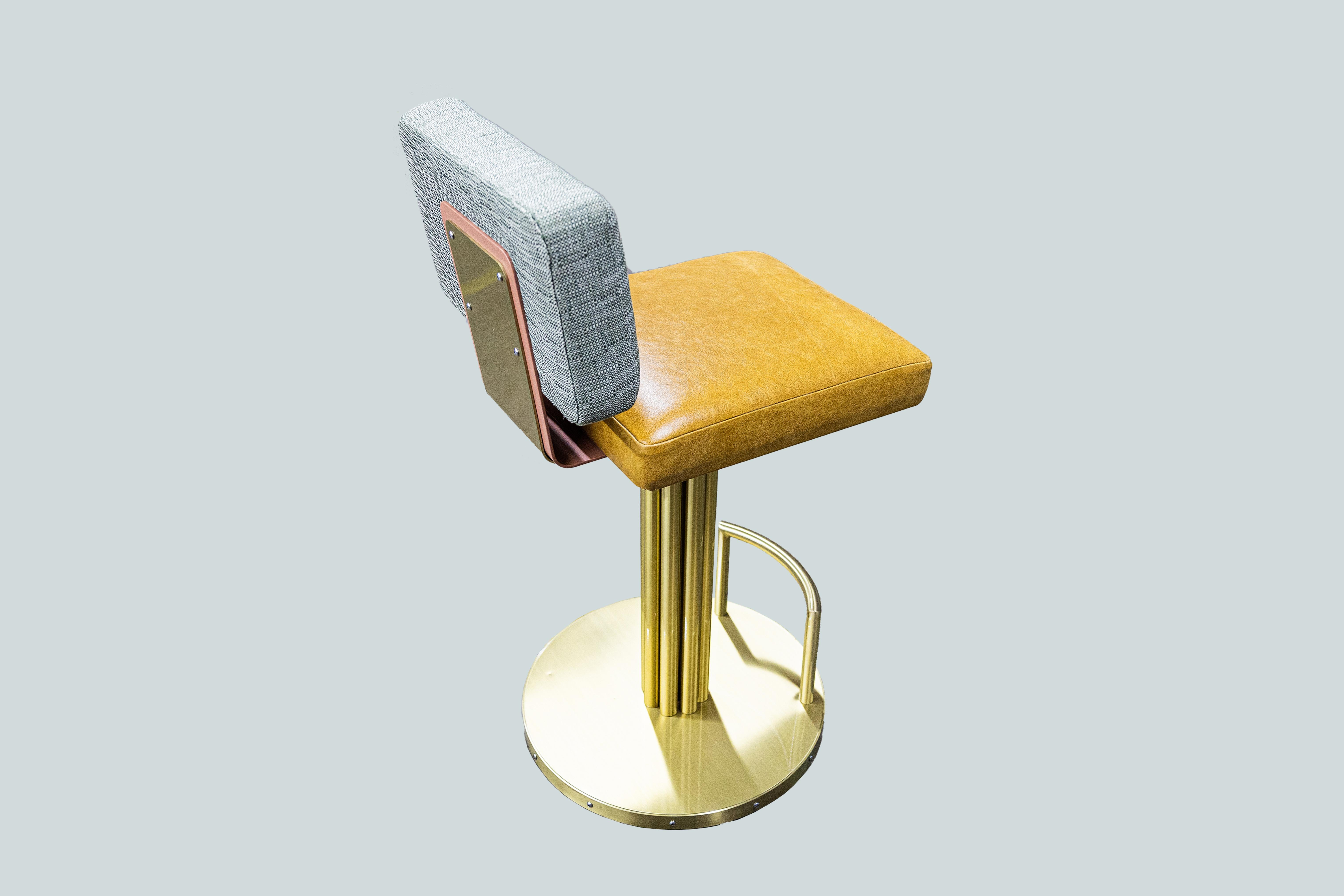 Designed by Basile Built, renowned Design-Fabrication Studio based in San Diego, California, this upholstered bar stool joins comfort and durability, featuring fabric back, leather seat and brass legs and base for a luxurious look.
