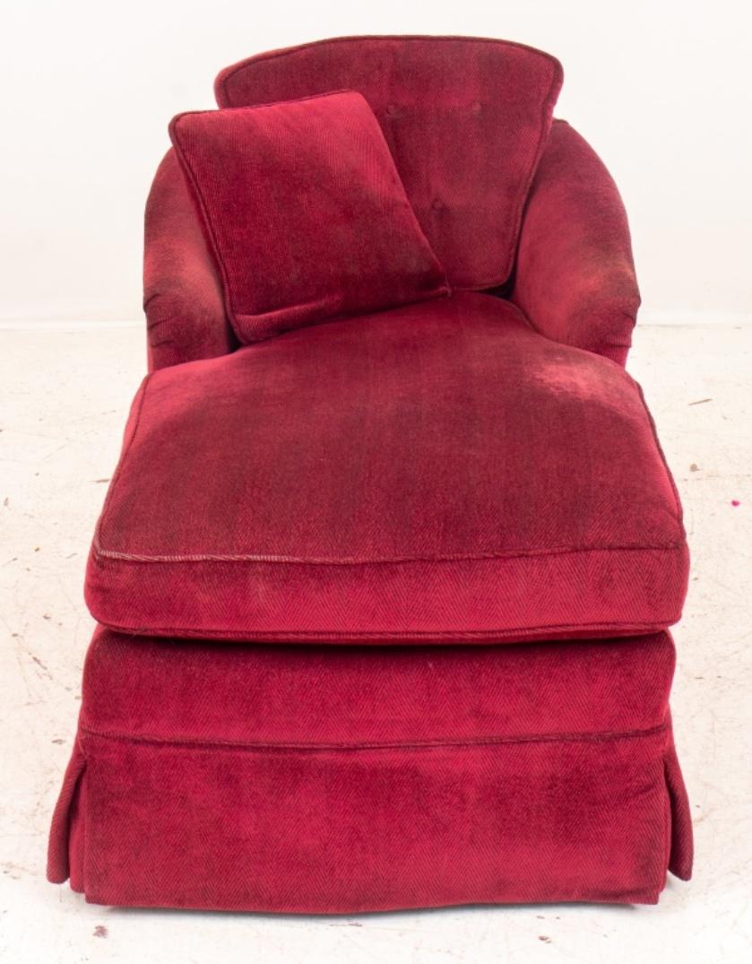 Upholstered chaise lounge, covered in garnet red chenille, the scoop back and scrolling arms with long skirted seat. In good condition. Wear consistent with age and use.

Dimensions: 29