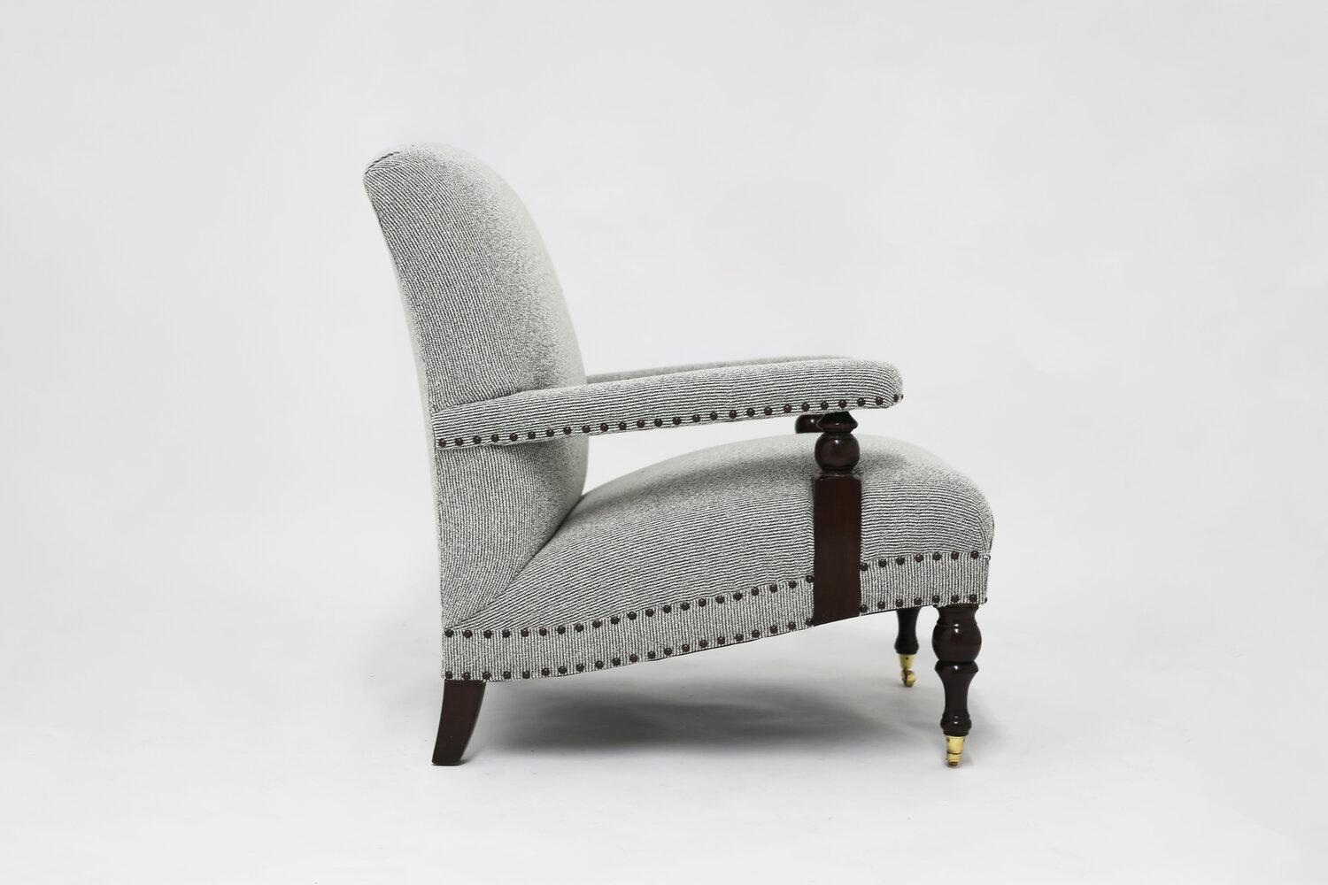 The Colin club chair is an elegant addition to your Den or Library. All handcrafted in our shop in Brooklyn, it is upholstered with hand tied springs and synthetic hair. Special nailhead trim with hand carved arm stretchers and legs and metal