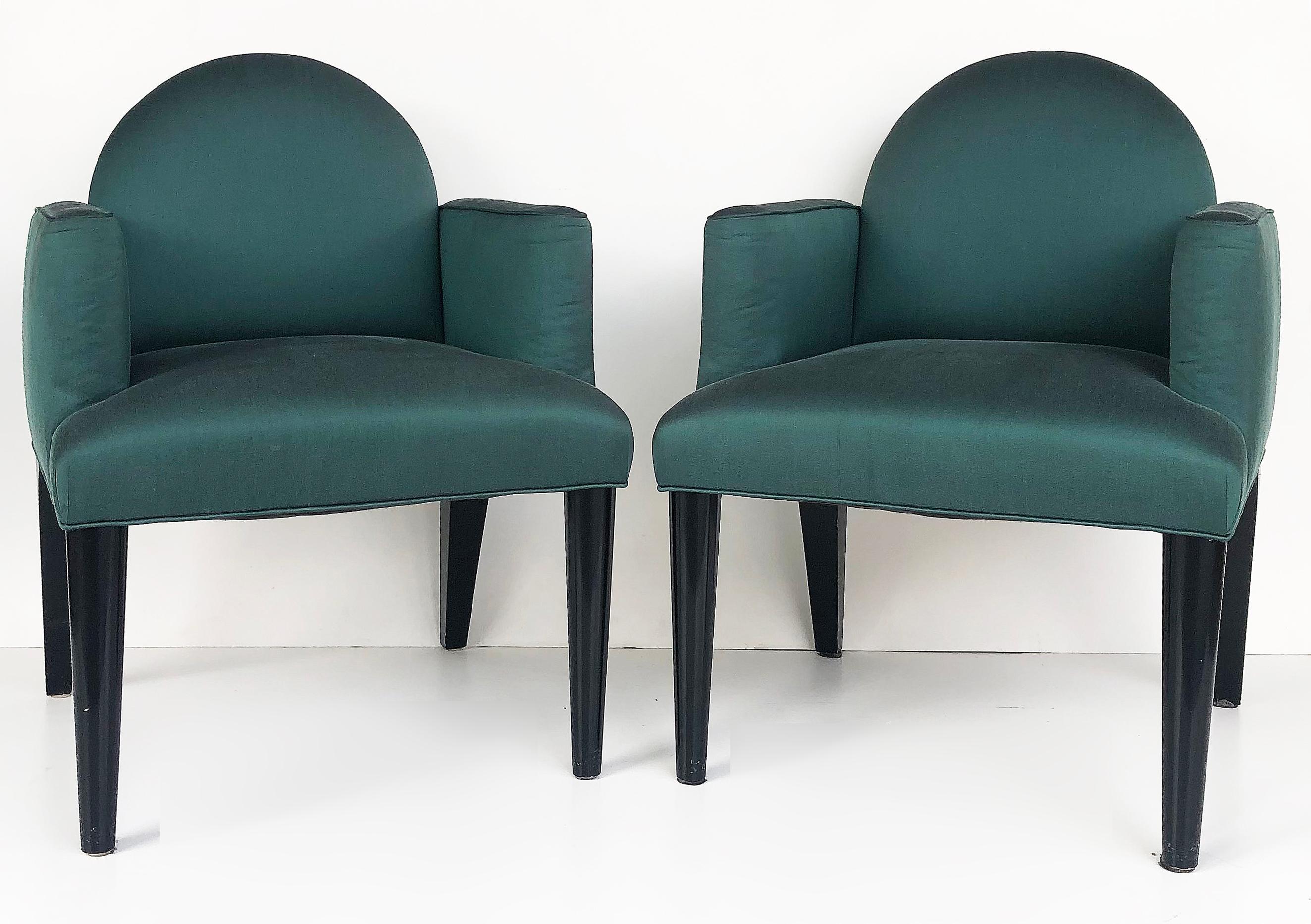 Upholsteredclub chairs with ebonized wood, Donghia Attributed 

Offered for sale is a pair of upholstered club chairs attributed to Donghia with ebonized frames. The chairs have tapering conical front legs and rounded backs that have a Postmodern