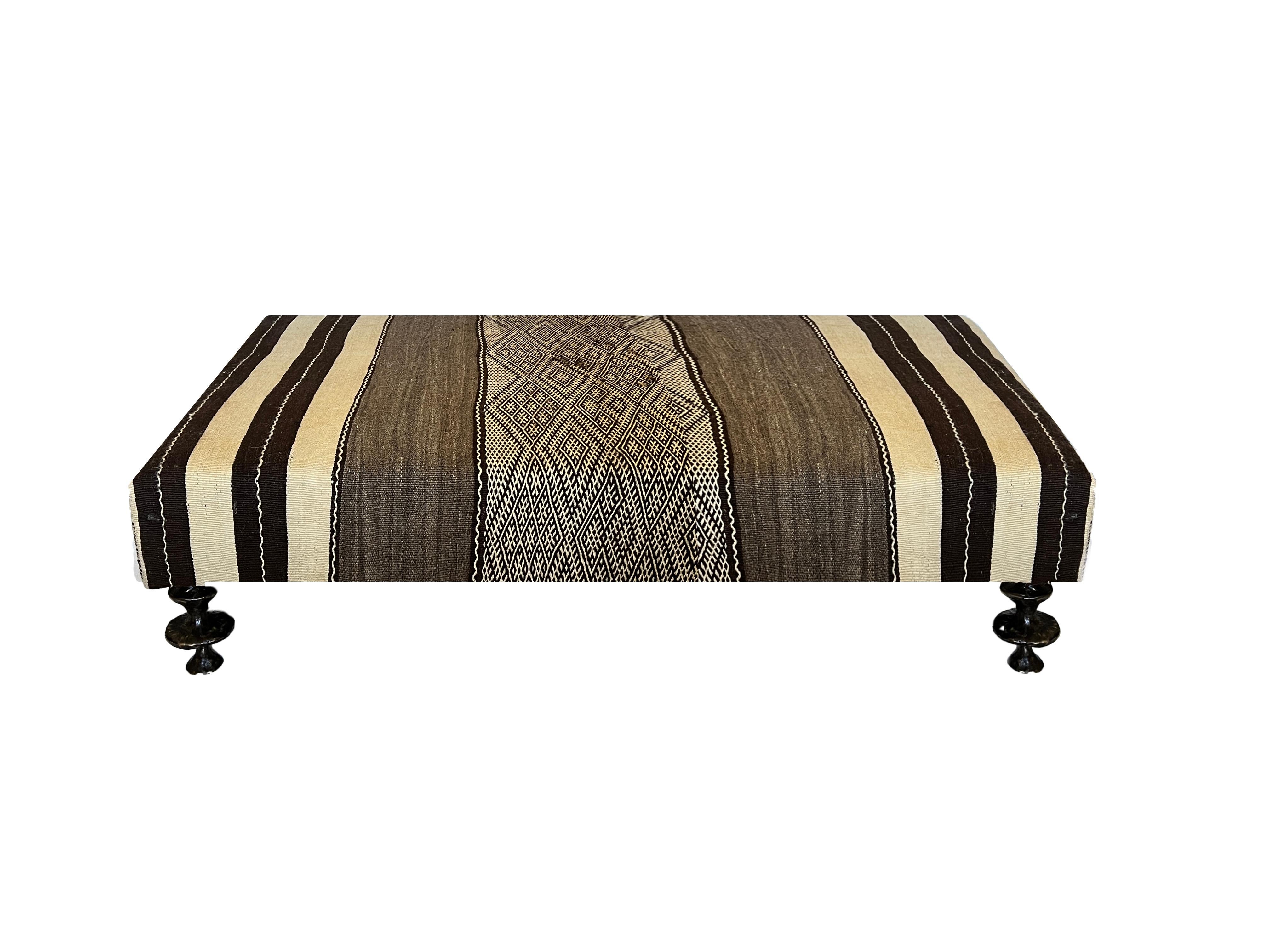 The distinctive Anouk Coffee Table is a perfect accent to soften a space with utilitarian function. The coffee table features hand sculpted legs in bronze. Custom sizes and finishes are available. Available in your own fabric or leather. Fabric not