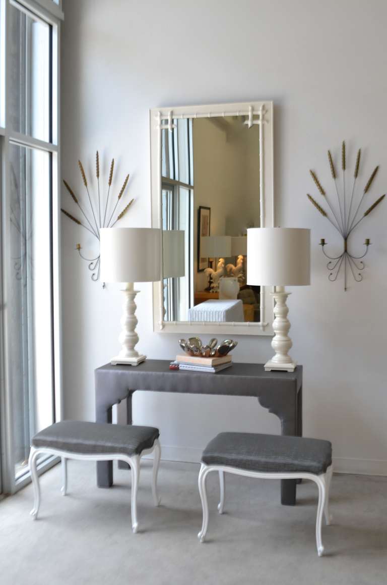 Hollywood Regency style upholstered console table, circa 1960s. This striking grey satin faux leather sofa table is custom designed with decorative modified scalloped detailing.