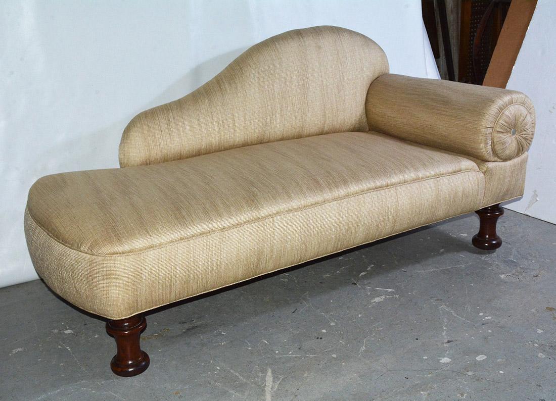 Graceful and inviting, the recamier chaise with arched back and rolled arm.  The fainting couch is upholstered but it does show some ware.  Although made in the Victorian period, it very much has the look of an art deco piece.  It lends itself to