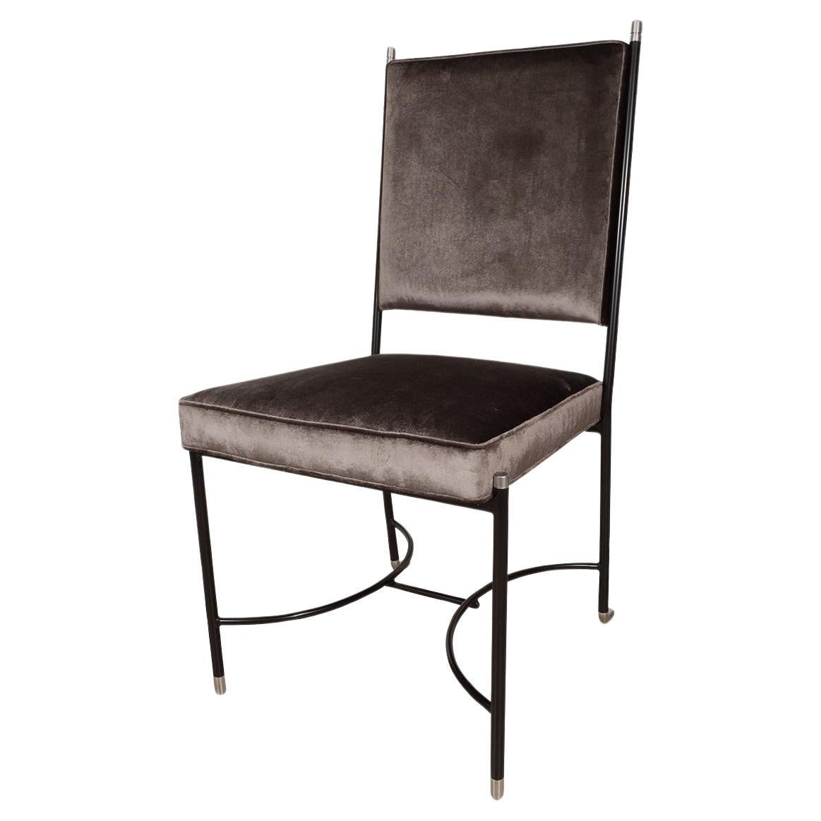 Upholstered desk chair with stylized blackened frame For Sale