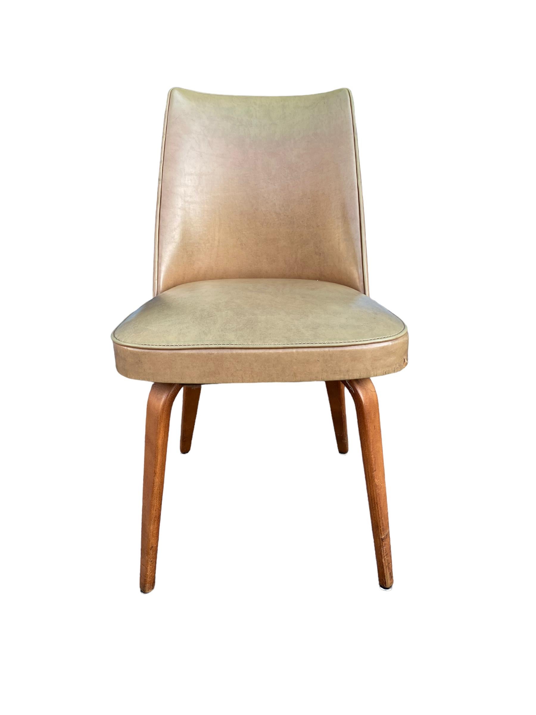 Elegant dining chair by Thonet featuring bentwood legs and cream leather upholstery