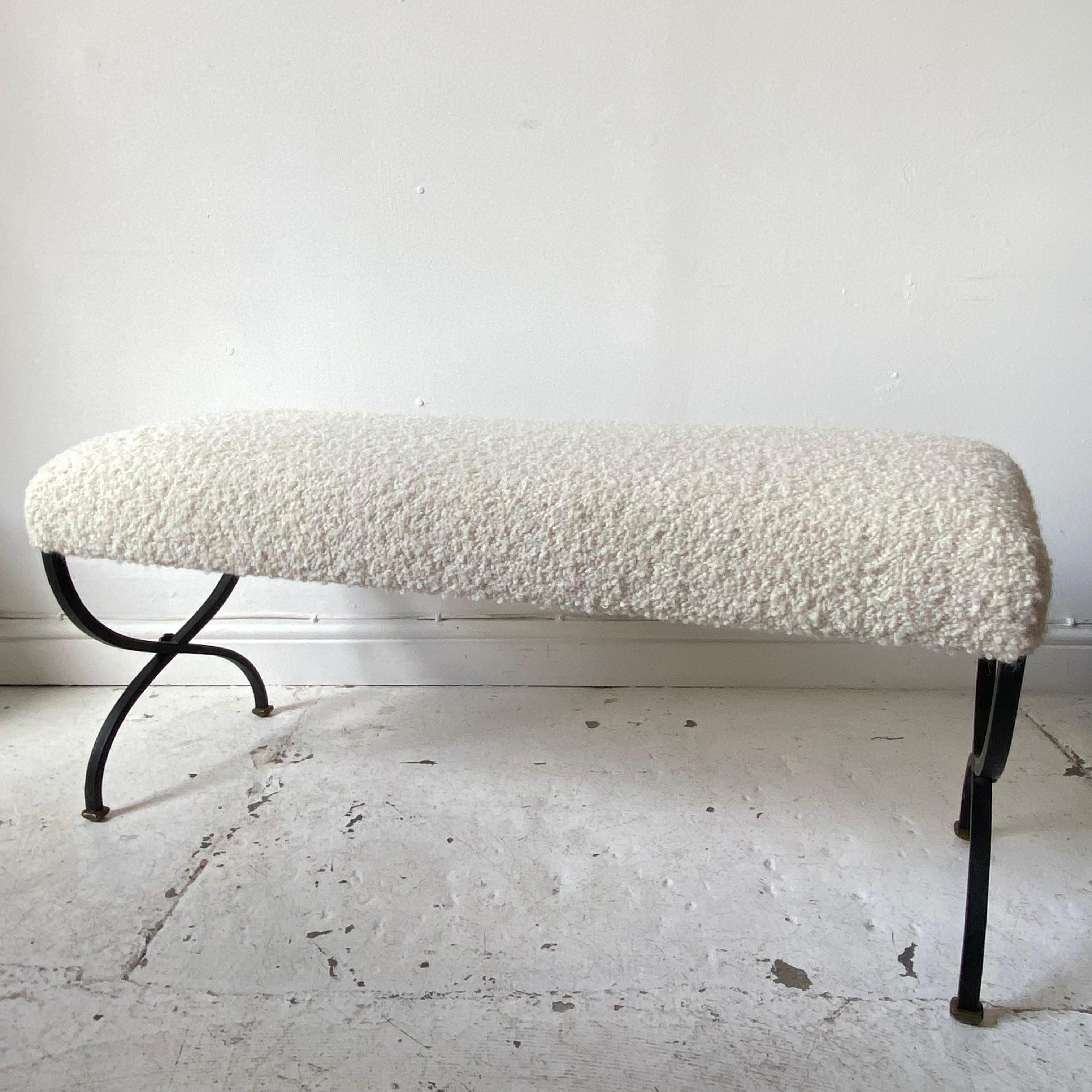 Upholstered entryway or bedroom bench seat with metal cross leg, featuring a pretty floral rosette to the centre and nice foot. The top is upholstered in a beautiful wool boucle. 
A Classic design it fits into most interiors. Good size.