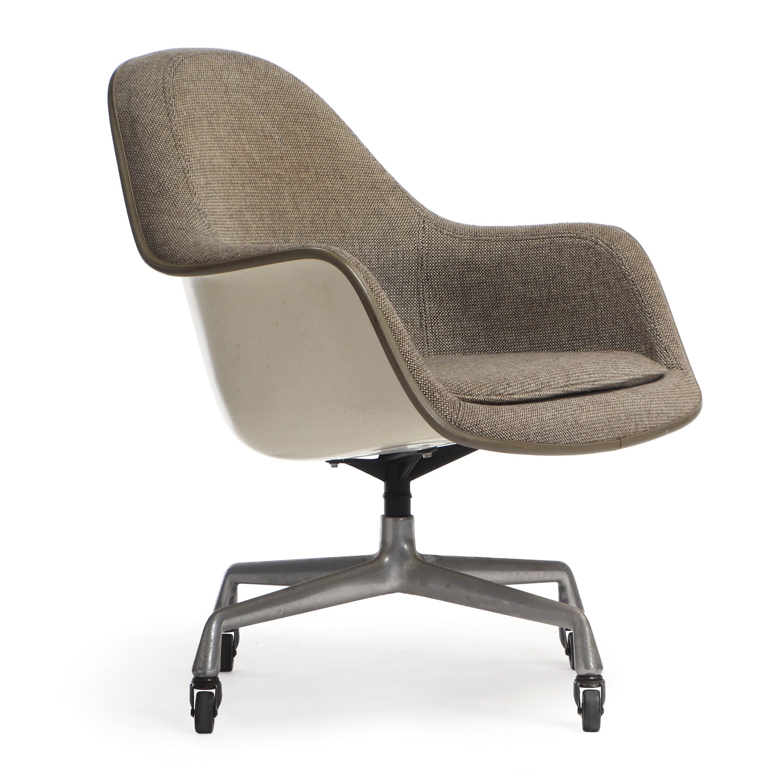 A fully adjustable upholstered desk chair by Charles Eames having a molded fiberglass body resting on an early four-pronged aluminum base with casters. Made by Herman Miller, circa 1970s in the USA. Marked November 1974.