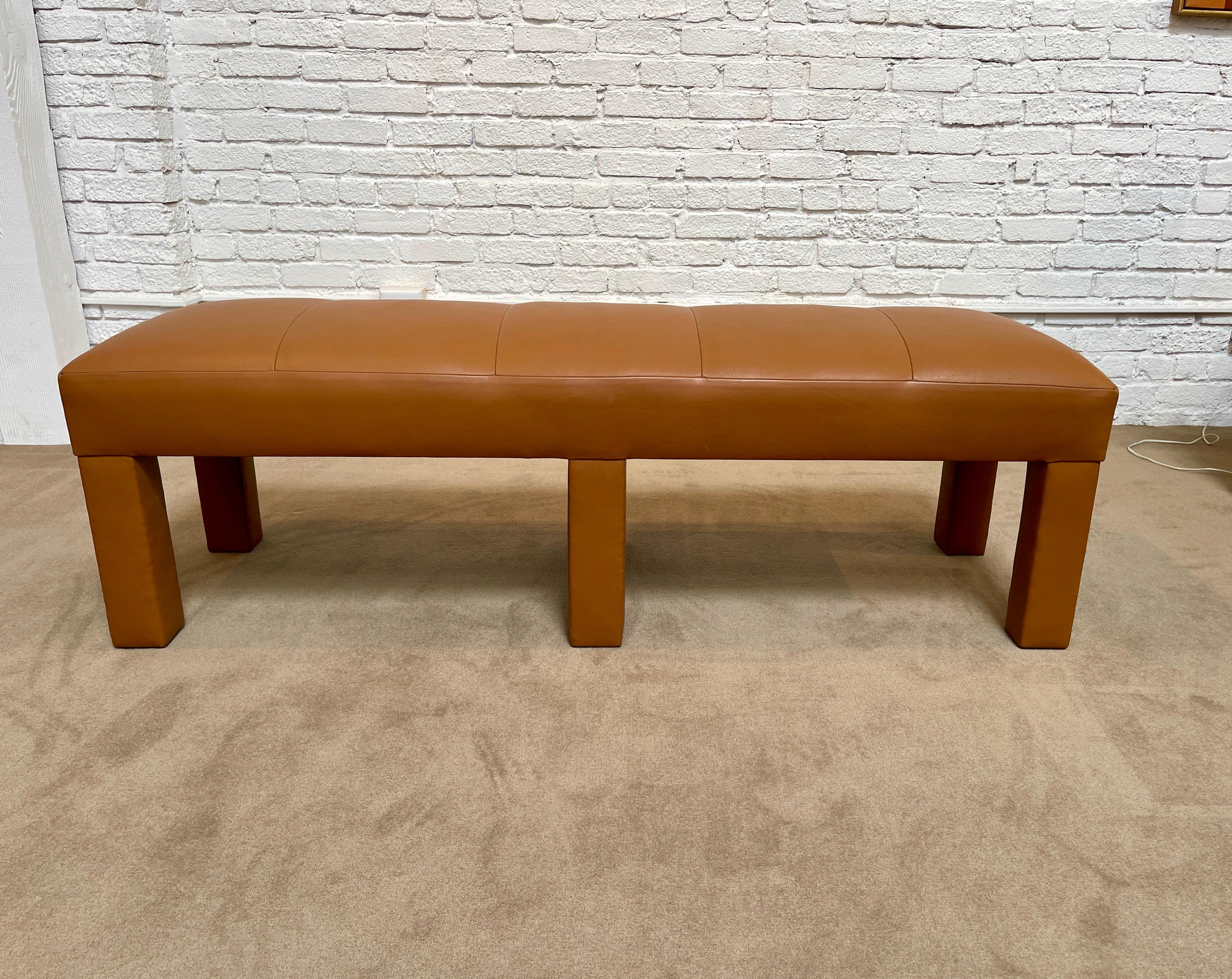 Excellent quality upholstered leather bench. Using the finest craftsmanship, the bench is sturdy and well made. Ready for use. Retains original cloth label - Randolph & Hein. Great for at the foot of a bed. Complementary delivery to the LA area.
