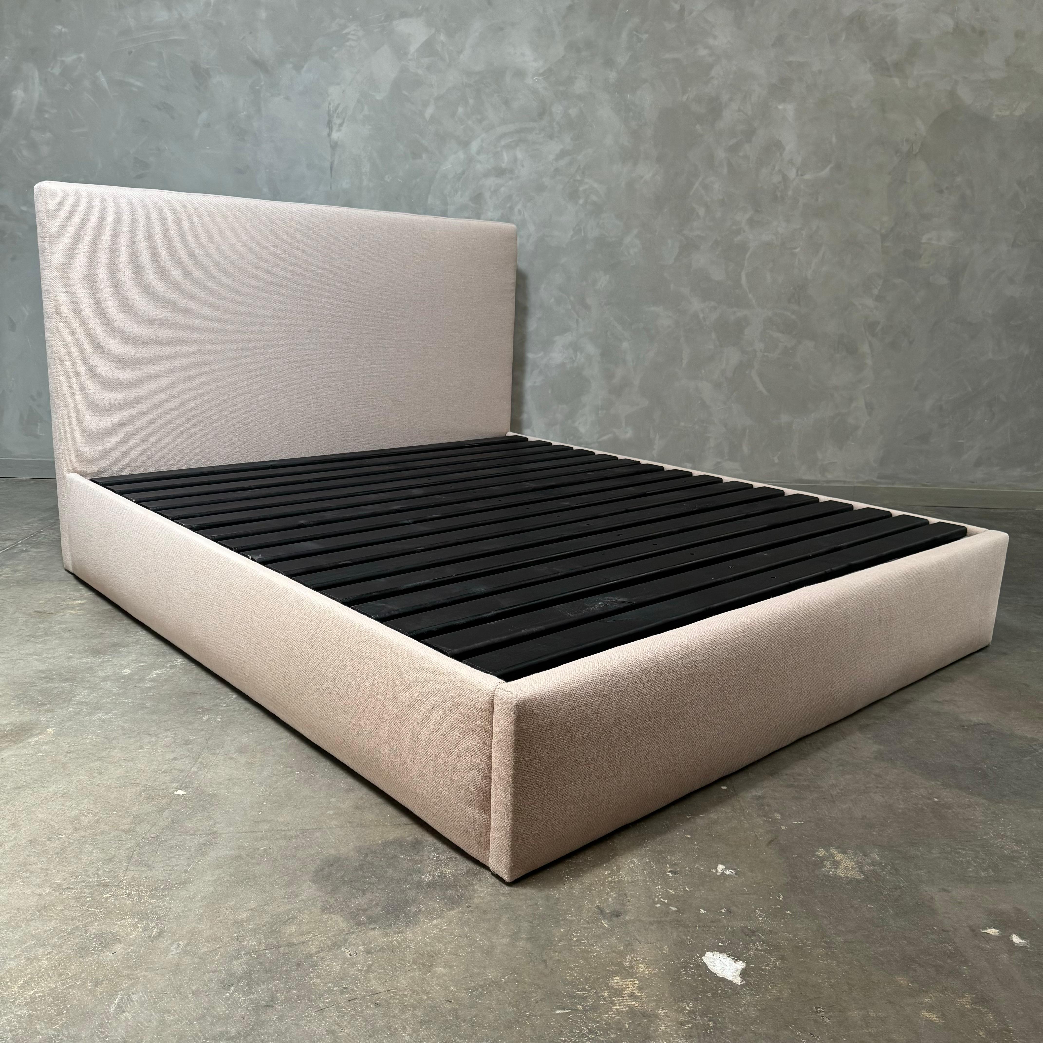 Distinguished by crisp lines and smooth contours, this platform bed is a non-tufted panel bed. Our non-tufted panel style is anchored by a luxuriously upholstered headboard. The fully-upholstered bed in luxurious Nude colored linen is made to fit