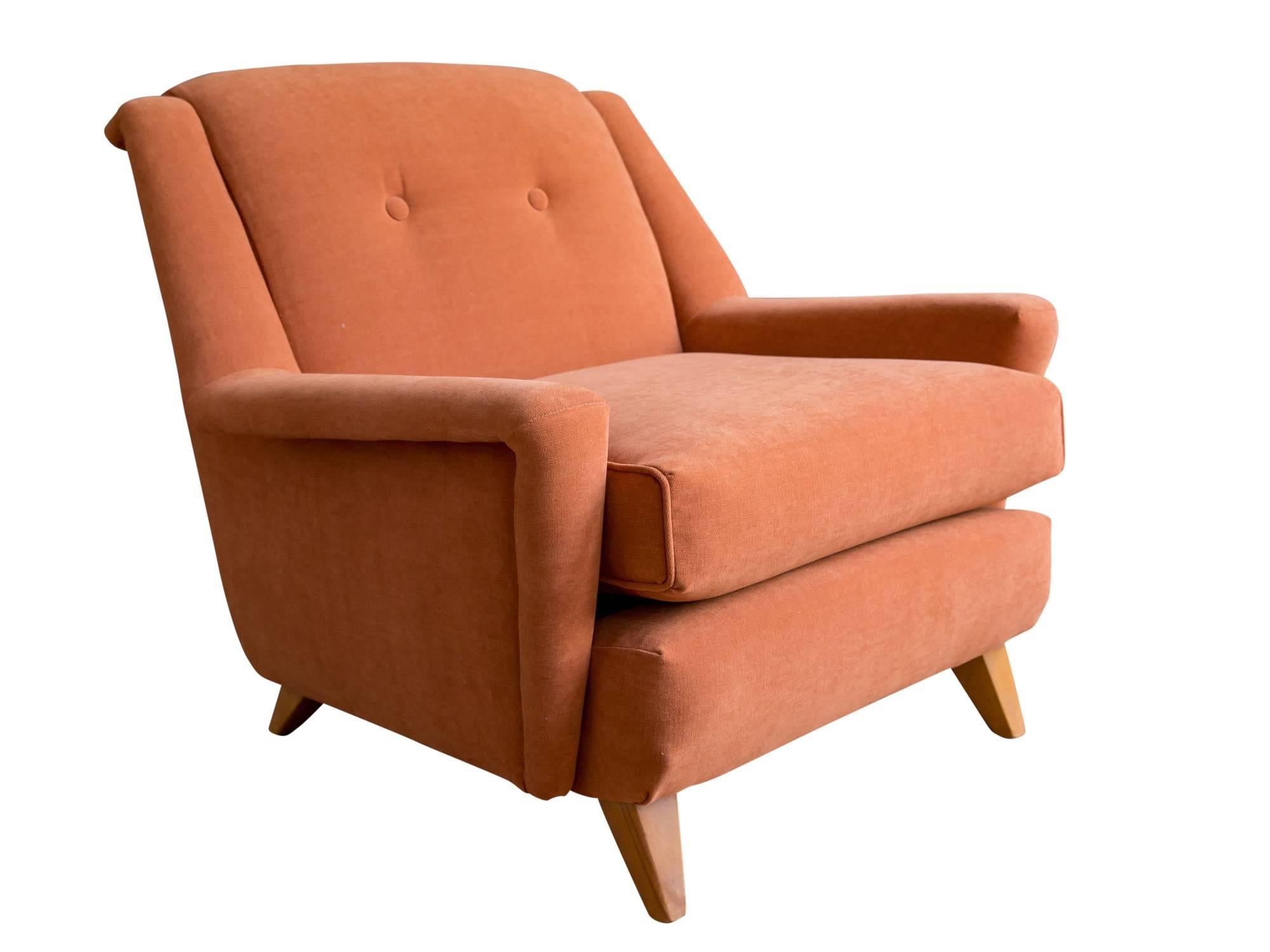 A generously sized lounge chair by Heywood Wakefield, circa 1950s. Featuring a Modernist sculptural form with wide arms and high back supported by flared maple legs. Recently upholstered in a terracotta cotton chenille. 

A comfortable reading