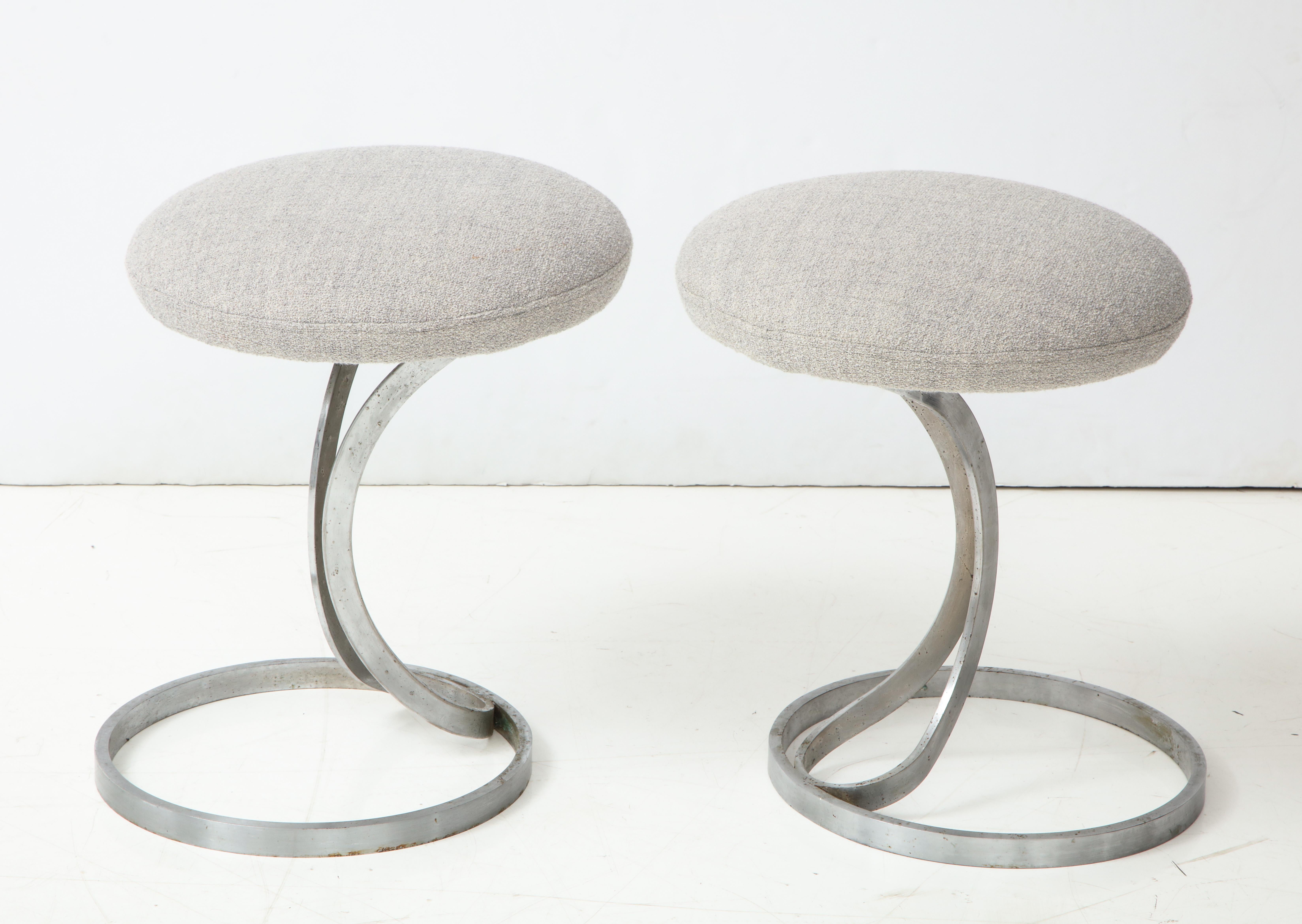 Upholstered metal stools by Boris Tabacoff, France, 1970s.

These elegant stools exhibit the sinuous lines + signature sphere base typical of Tabacoff's postwar design work. The stools have been newly reupholstered in a textured light grey boucle