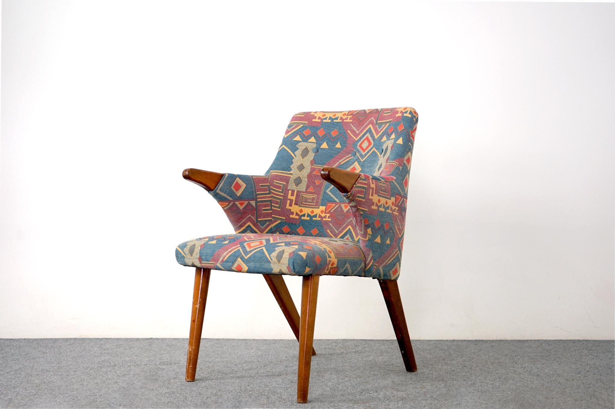 Upholstered mid century arm chair, circa 1960's. Sweet silhouette on this sculpted chair, beech wood hand rests and legs offer great contrast to the fabric. Very comfortable, fabric and foam was recenty updated, years of life in it yet. 

Hand
