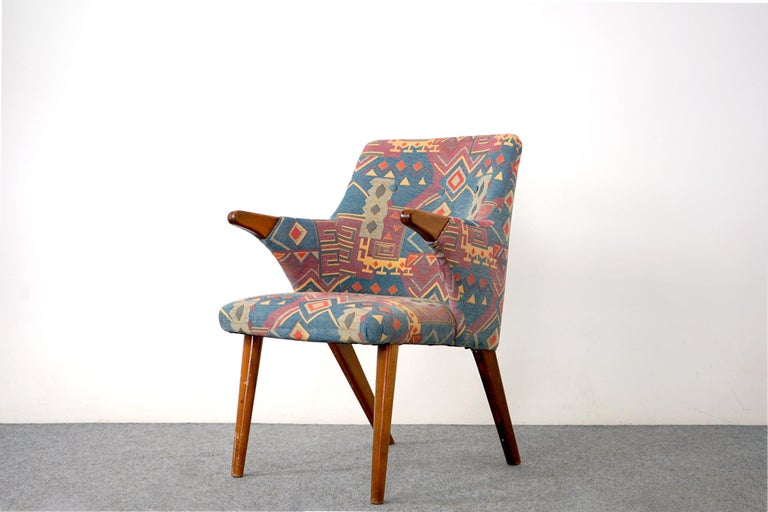 Upholstered mid century arm chair, circa 1960's. Sweet silhouette on this sculpted chair, beech wood hand rests and legs offer great contrast to the fabric. Very comfortable, fabric and foam was recenty updated, years of life in it yet. 

Hand