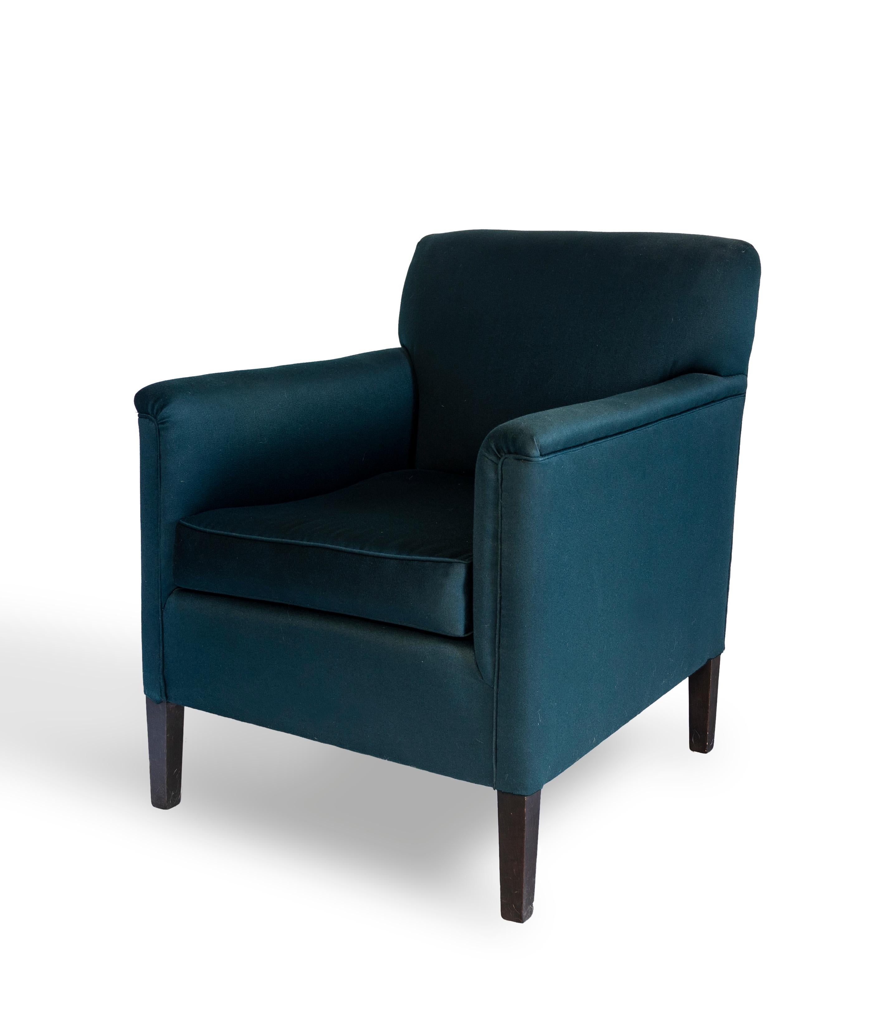 The Herbert chair has a tight upholstered back and loose seat cushion. Tapered front legs and curved back legs are made of blackened hardwood.

Made to order and handcrafted in the USA. Available in wool in a range of colors including dark gray,