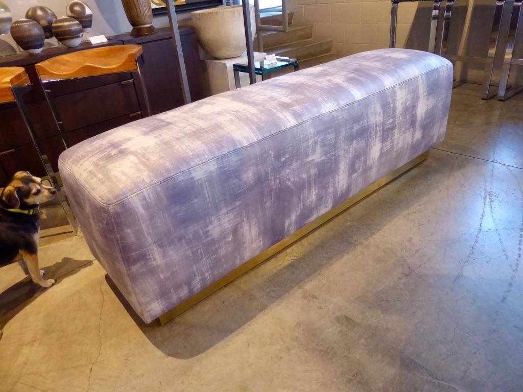 A newly reupholstered ottoman/bench in the style of noted interior designer, Steve Chase, circa 1980s. The base of the ottoman has a durable brass coating over wood and the upholstery is printed leather with 