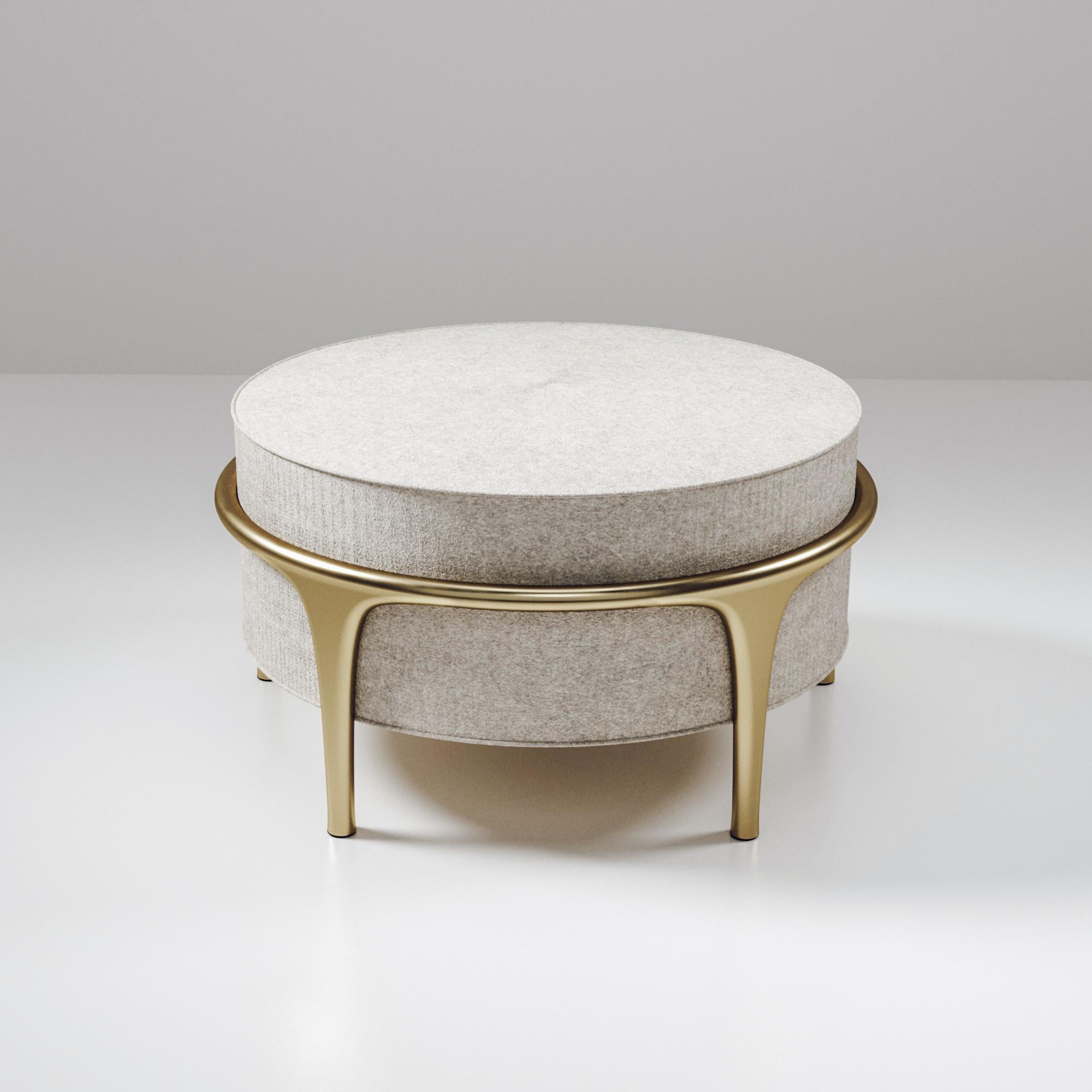 The Ramo ottoman by R & Y Augousti is an elegant and versatile piece. The upholstered piece in cream Pierre Frey fabric provides comfort while retaining a unique aesthetic with the bronze-patina brass frame and details. This listing is priced for