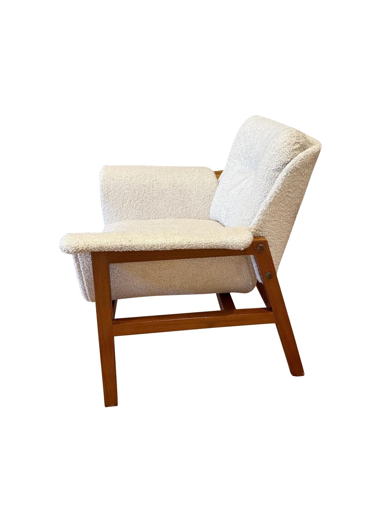 Mid Century Italian pair fully upholstered side chairs with wooden legs. 
Curved upholstered arms.
Tufted back.
Newly reupholstered in boucle fabric.
Frame recently refurbished.
Very comfortable.