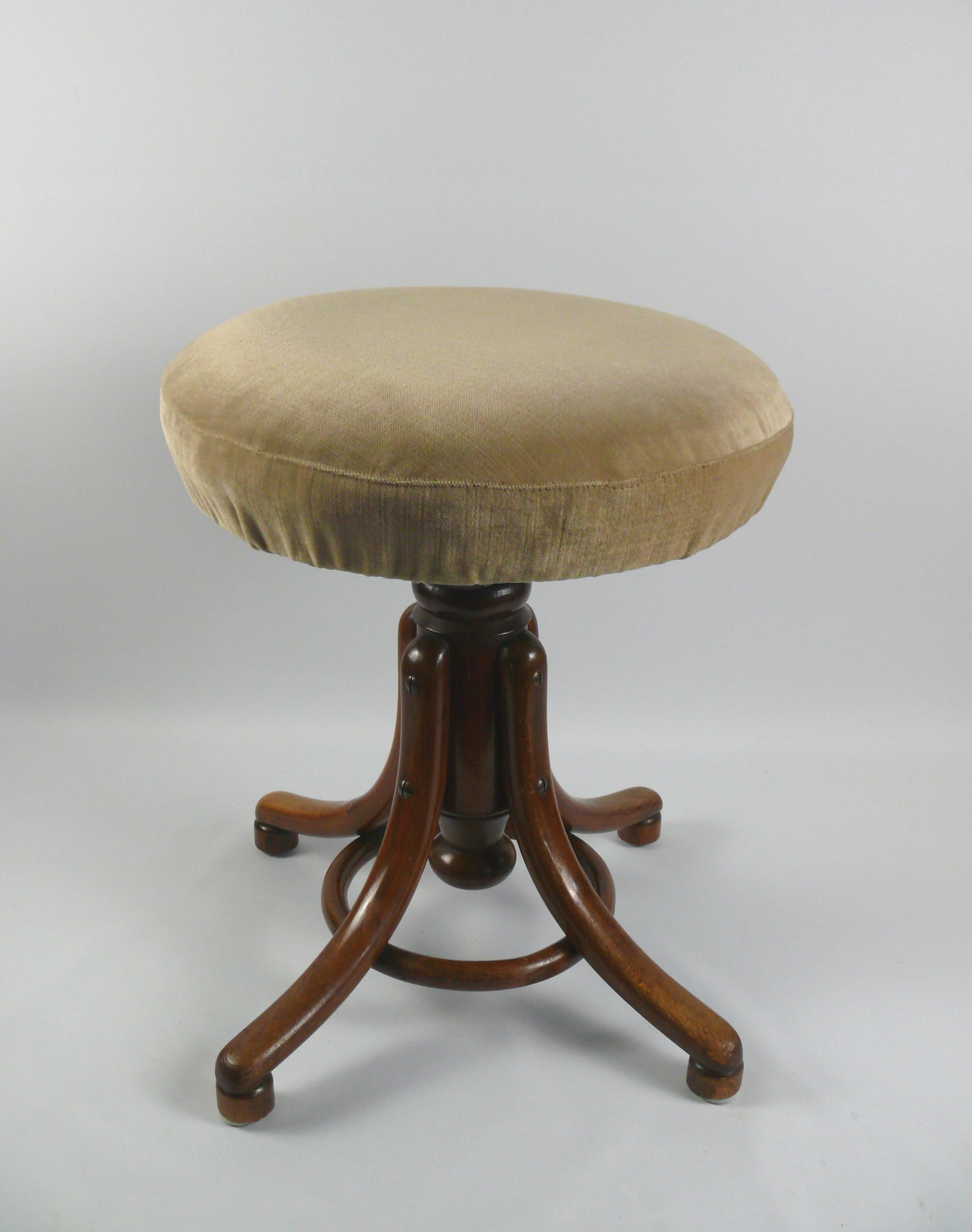 Swivel stool No.1 from the traditional company Gebrüder Thonet, Vienna from the late 19th century. The piano stool is made of lacquered wood (shellac) and has a frame with a bentwood ring. The curved feet are held together by the wooden ring made of