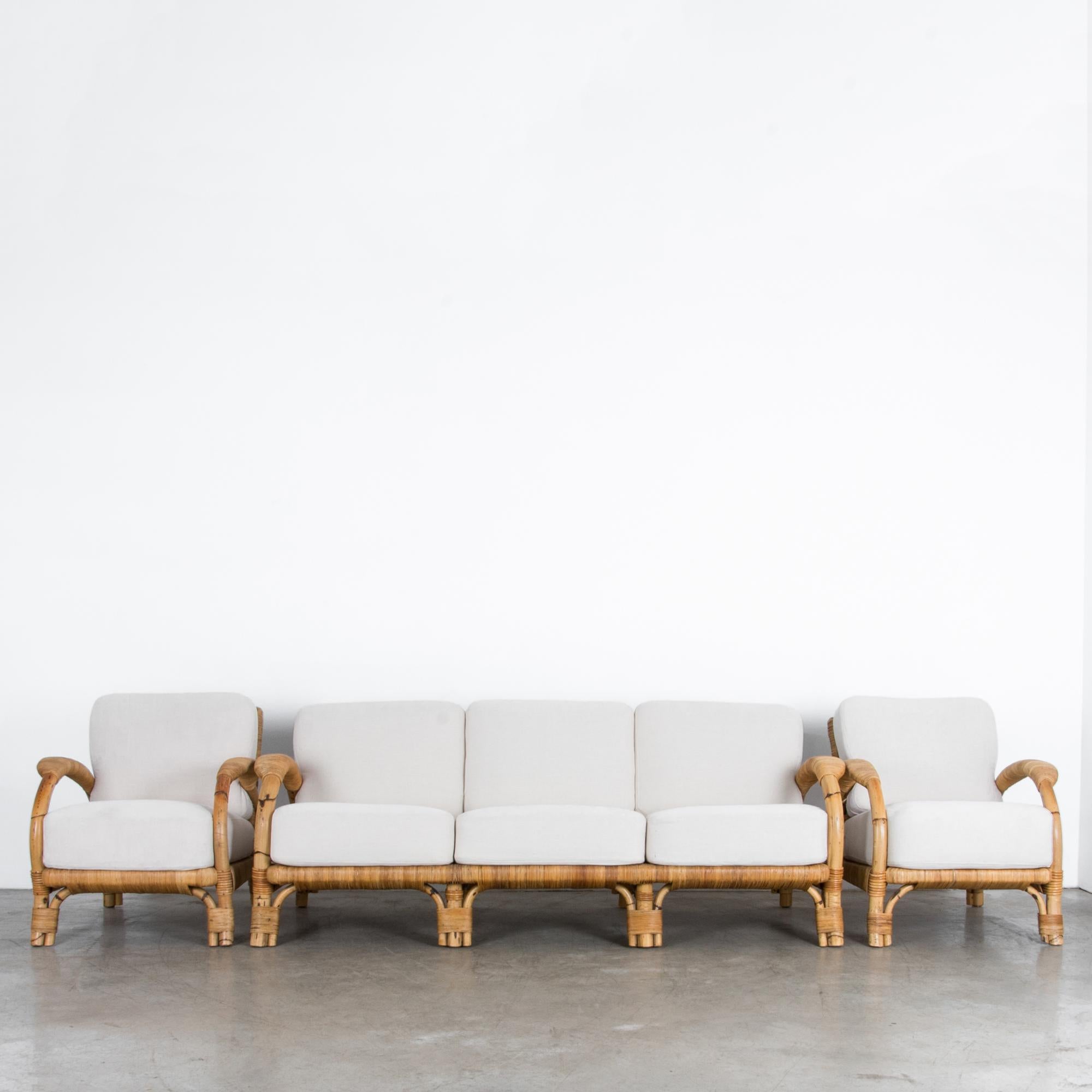 A three piece sofa set from circa 1970, produced by German manufacturer “Arco.” This vintage piece has a great modern vibe, subtly aged with the colors and textures of nature. The warm brown rattan is crafted with the highest quality, and updated in