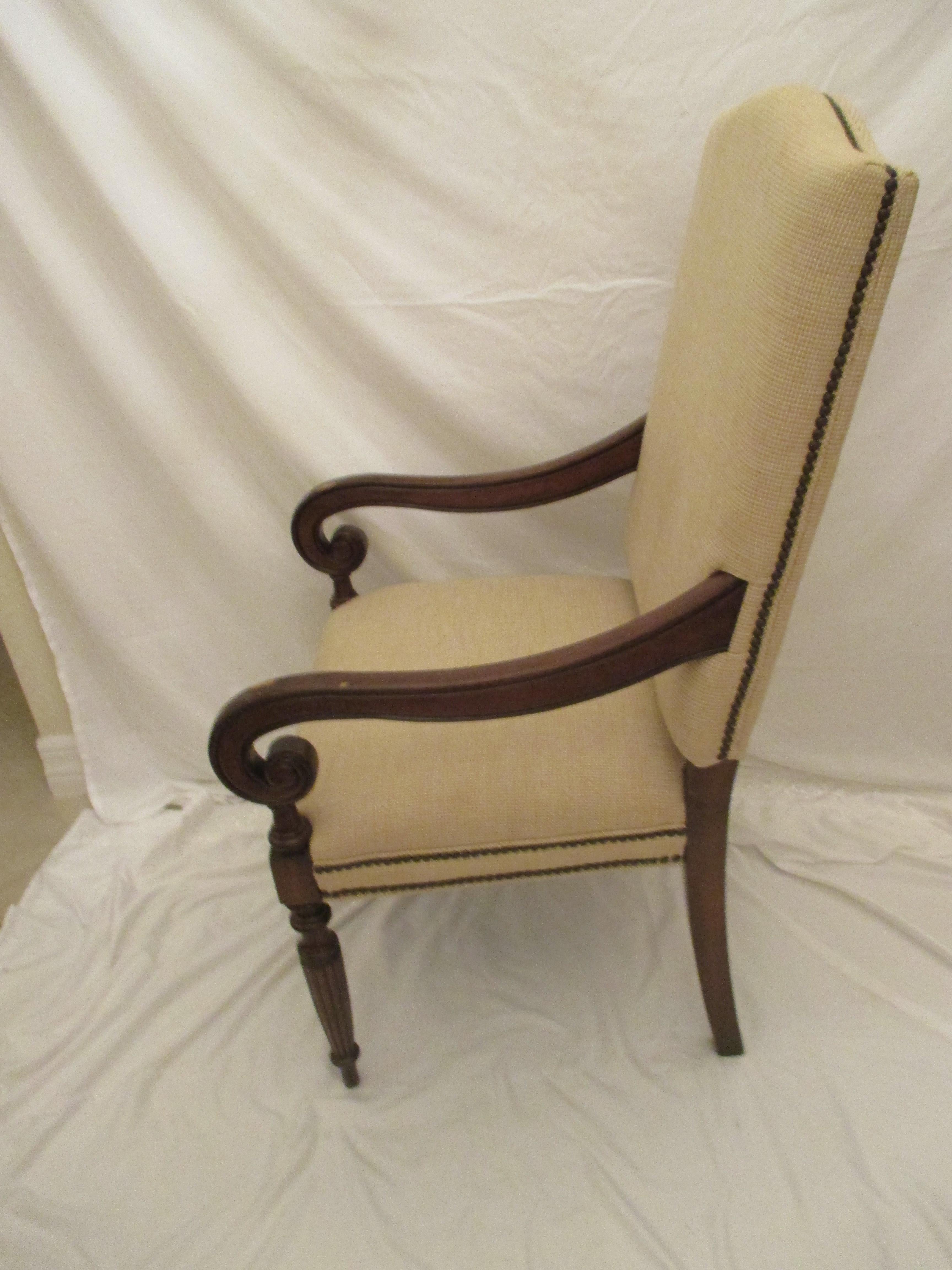 Tall upholstered club chair with arms. Chair has original upholstery in good condition with nailhead trim. Arms have signs of wear. Measurements are listed, however, floor to arm measurement is 26.75.”
