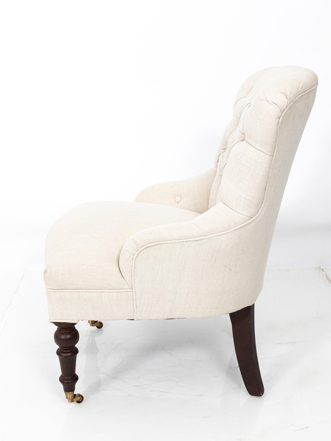 Upholstered slipper side chair with tufted button seating. Please note of wear consistent with age.