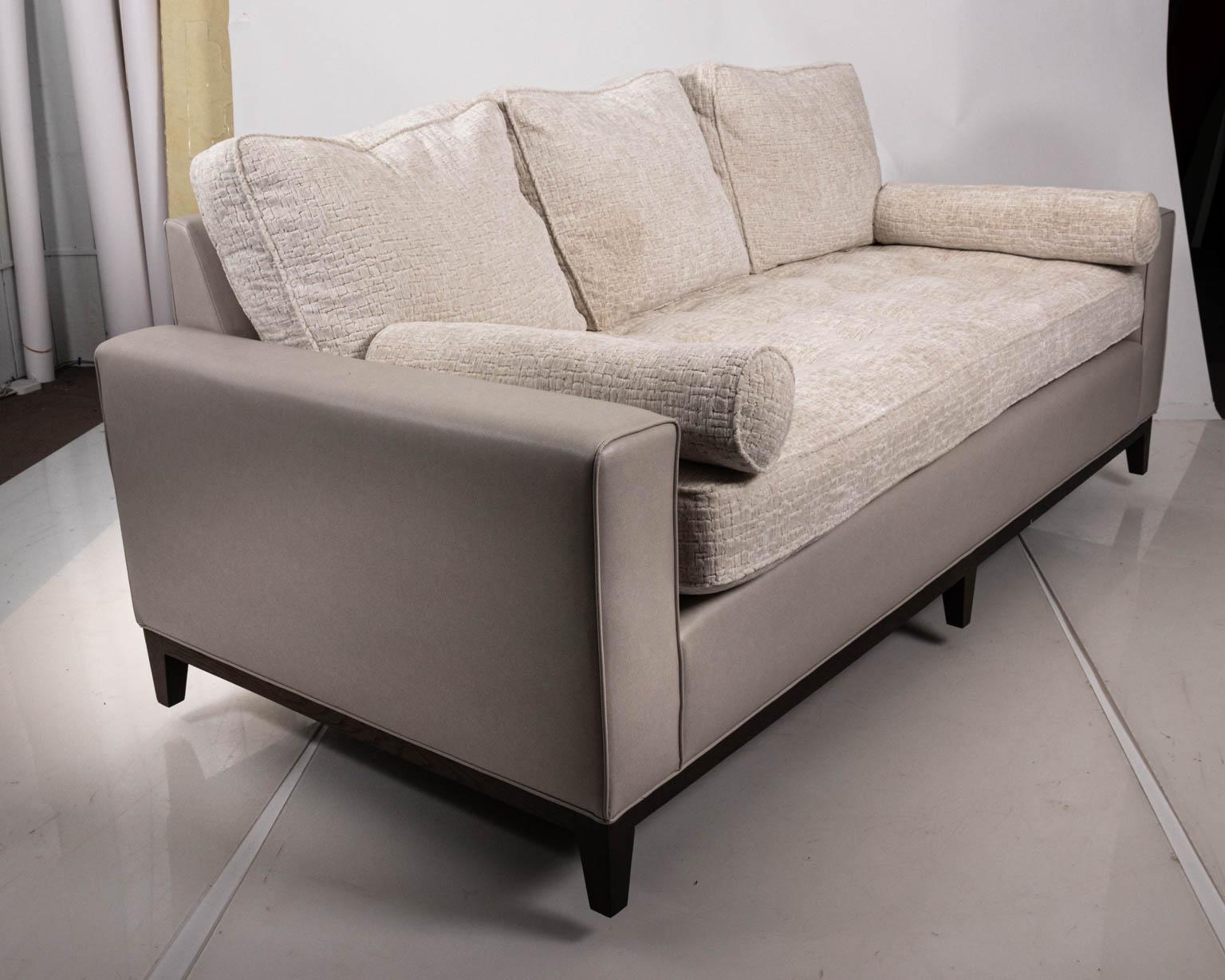 Upholstered sofa by Masters Interiors with dark oakwood base, circa 20th century. The piece features OWW fabric called 