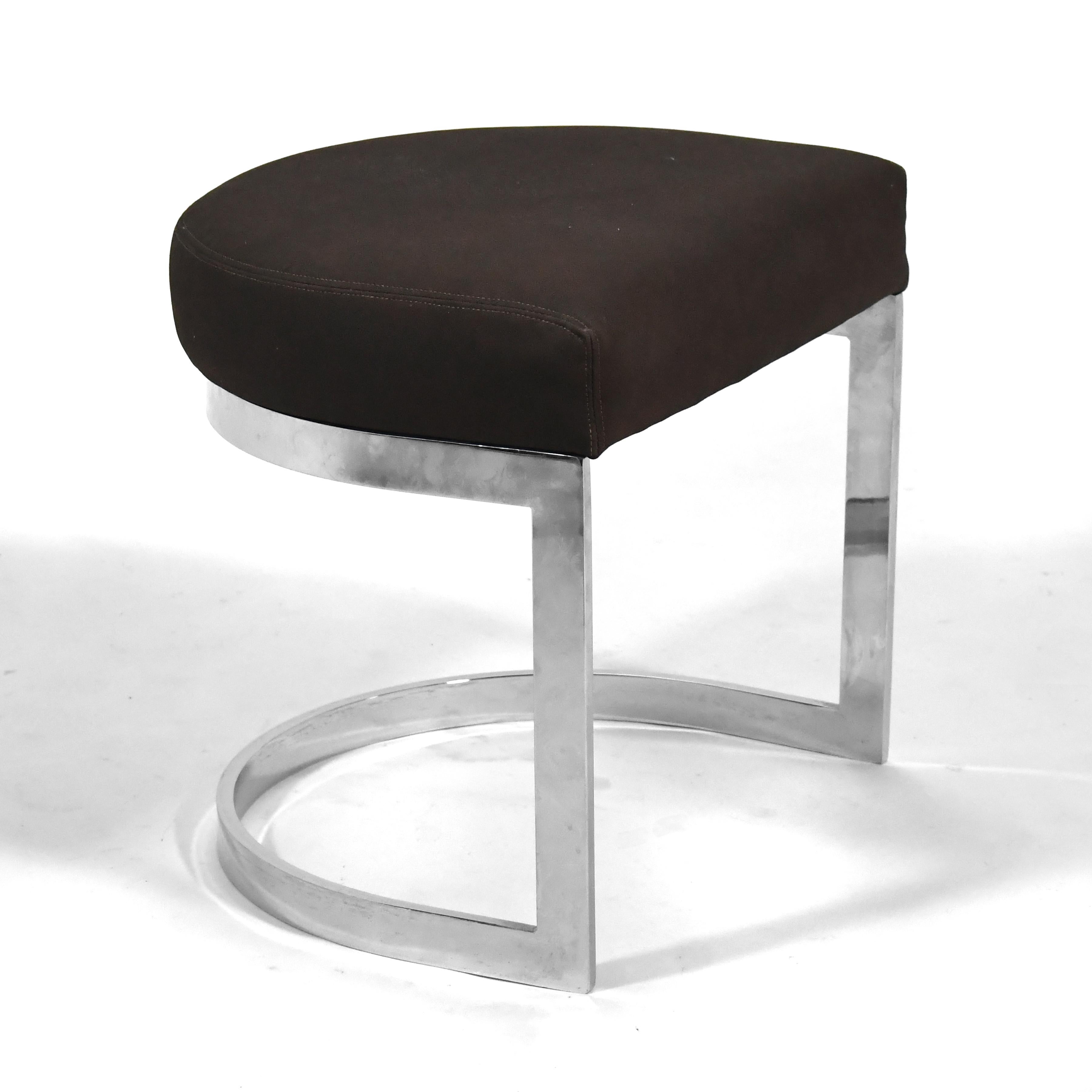 This sleek little stool has an half-round upholstered seat supported by chromed steel cantelievered base. The design reminds us of a similar design by Warren Bacon and shares qualities with the work of Milo Baughman.

18.5