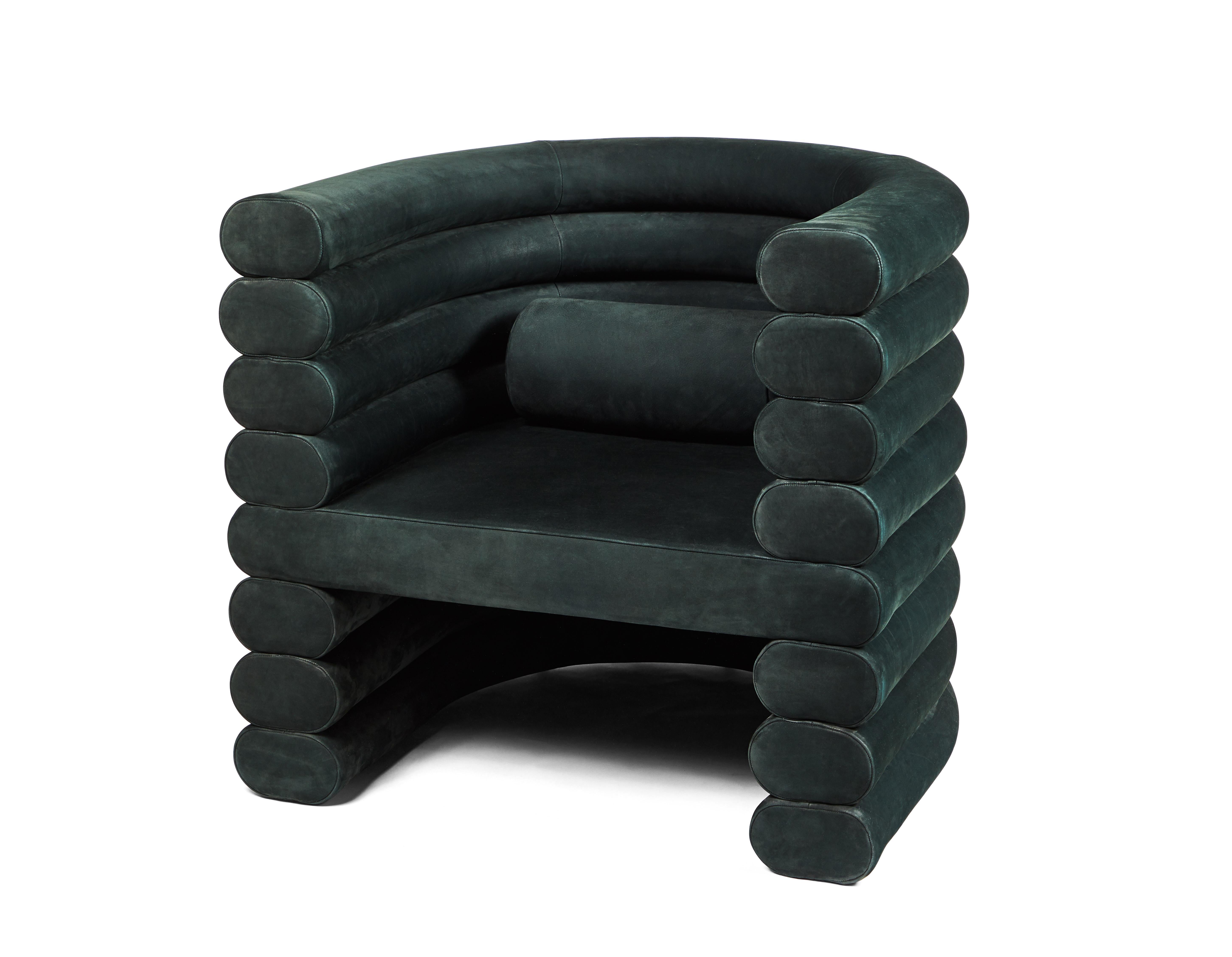 The Rhea chair is shown in Jade upholstery. This is considered a sculptural upholstered club chair. Each section/tube is hand carved at a small shop in Los Angeles and then masterly upholstered. Each chair also come with a tube bolster for lower