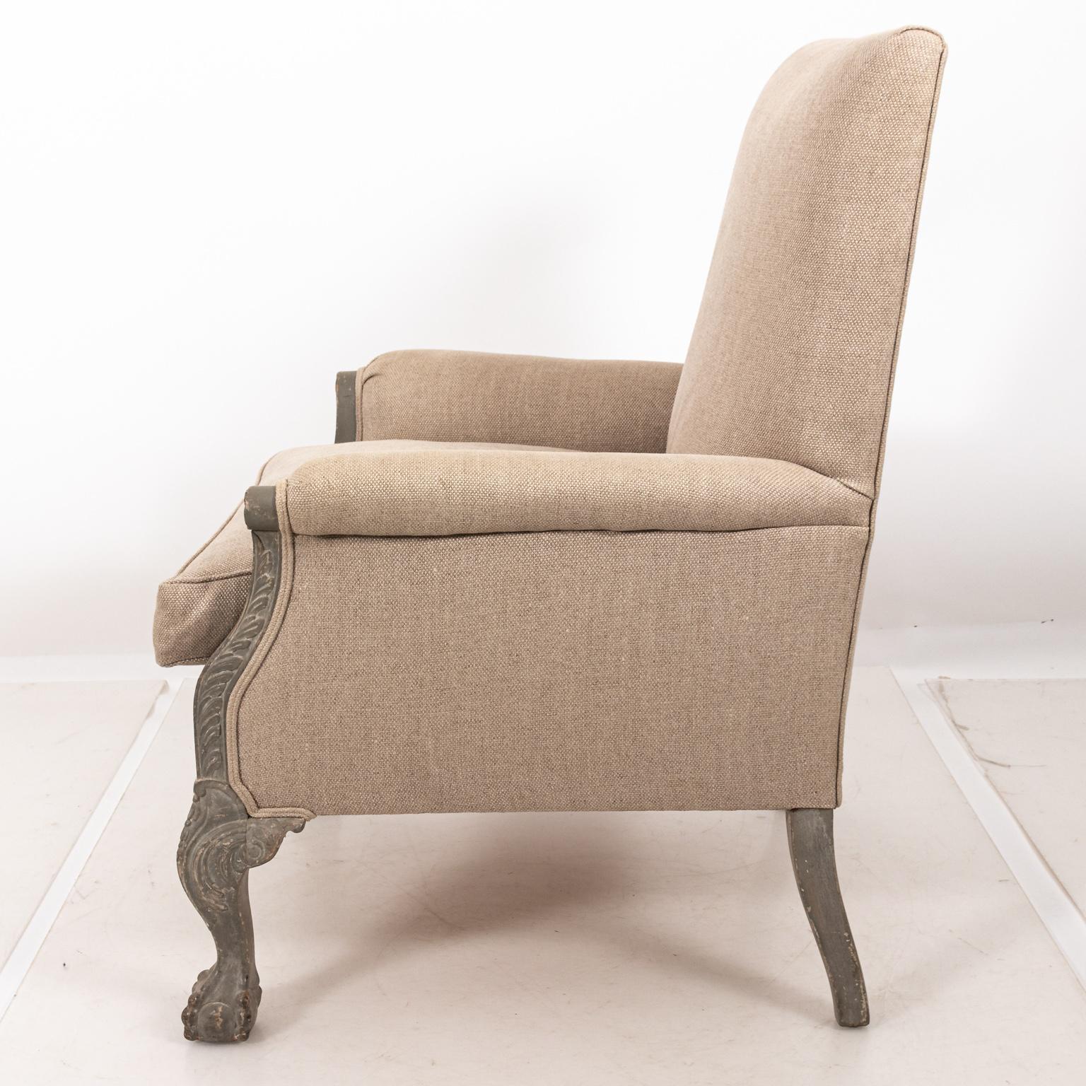 Fully upholstered Victorian lounge armchair with gray painted frame and ball and claw feet, circa 1850s. The piece also features sand colored Belgian Linen. Please note of wear consistent with age including distressed finish.