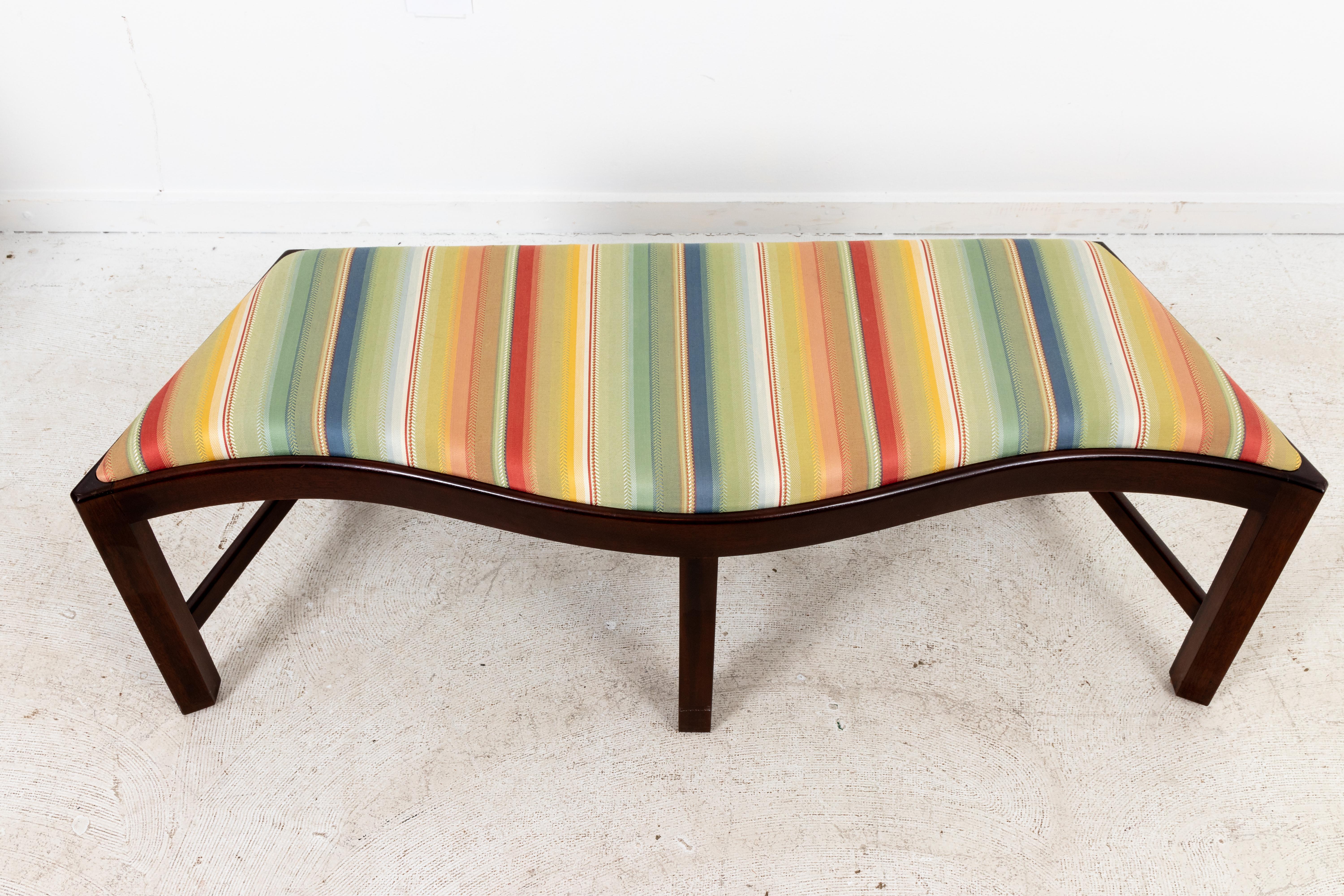 Upholstered window bench with angled sides and curvy front. In clean striped upholstery.
Measures: 48