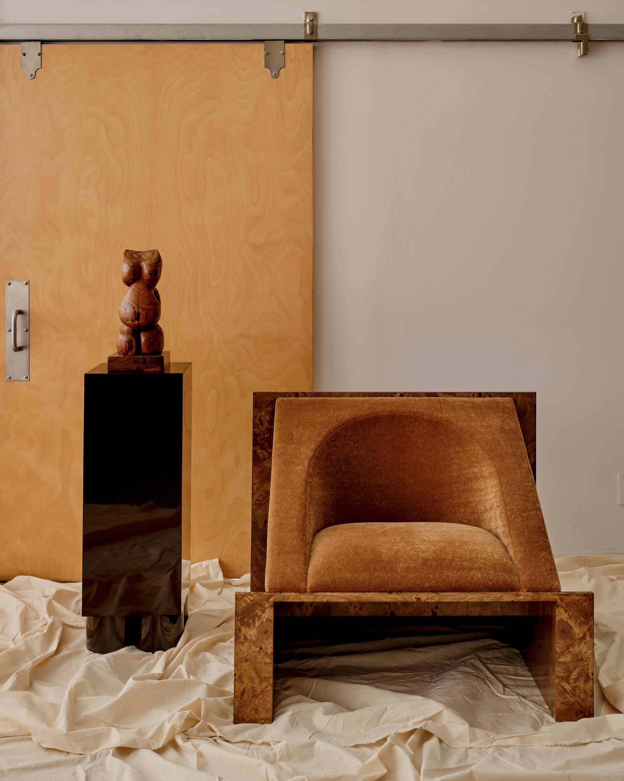 A graceful articulation of comfort through form, the Perception Chair explores the relationship between upholstery and framework. Its soft, sculpted interior creates cozy contours within a linear form. Available with a burl or maple frame and a