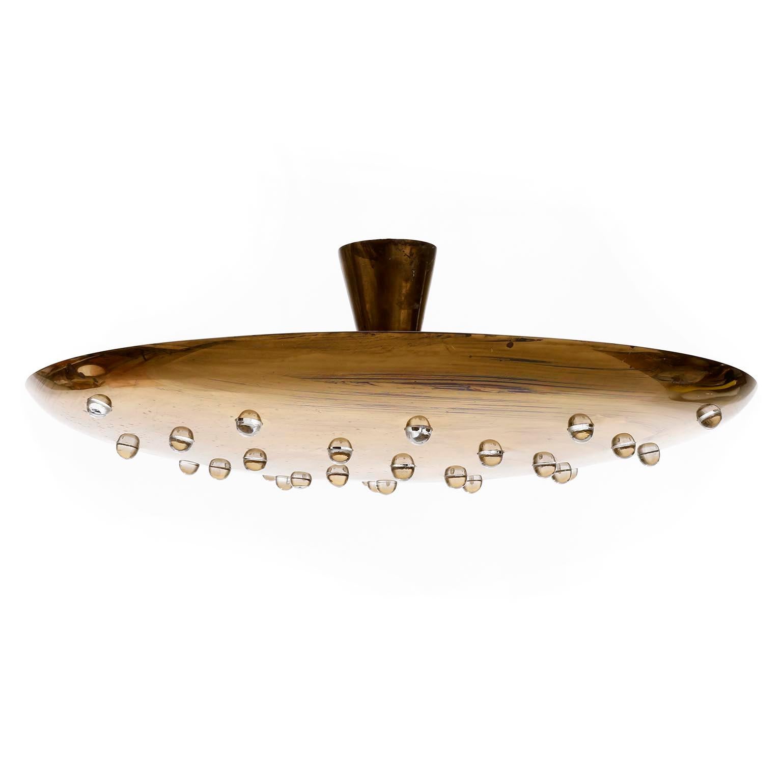 A solid brass uplight bowl light fixture manufactured in Italy in midcentury, circa 1960.
The bowl is pierced and has glass nubs which reflect the light also downwards.
The lamp is in very good condition with lovely patina. 
It can be used as flush