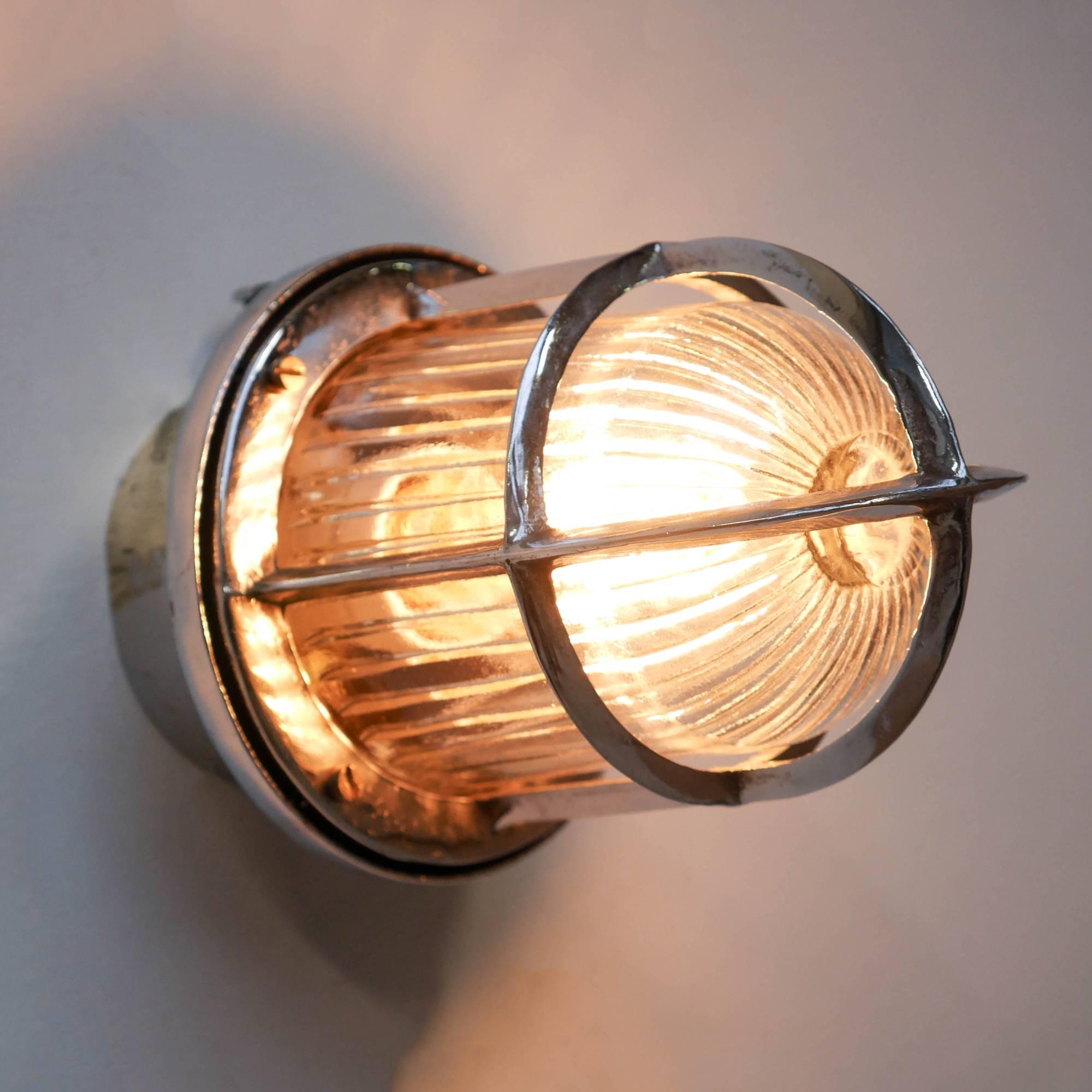 Old industrial wall light for outside, chrome-plated and polished. Very pretty glass with wide stripes offering a beautiful diffusion of the light on 360°.

 