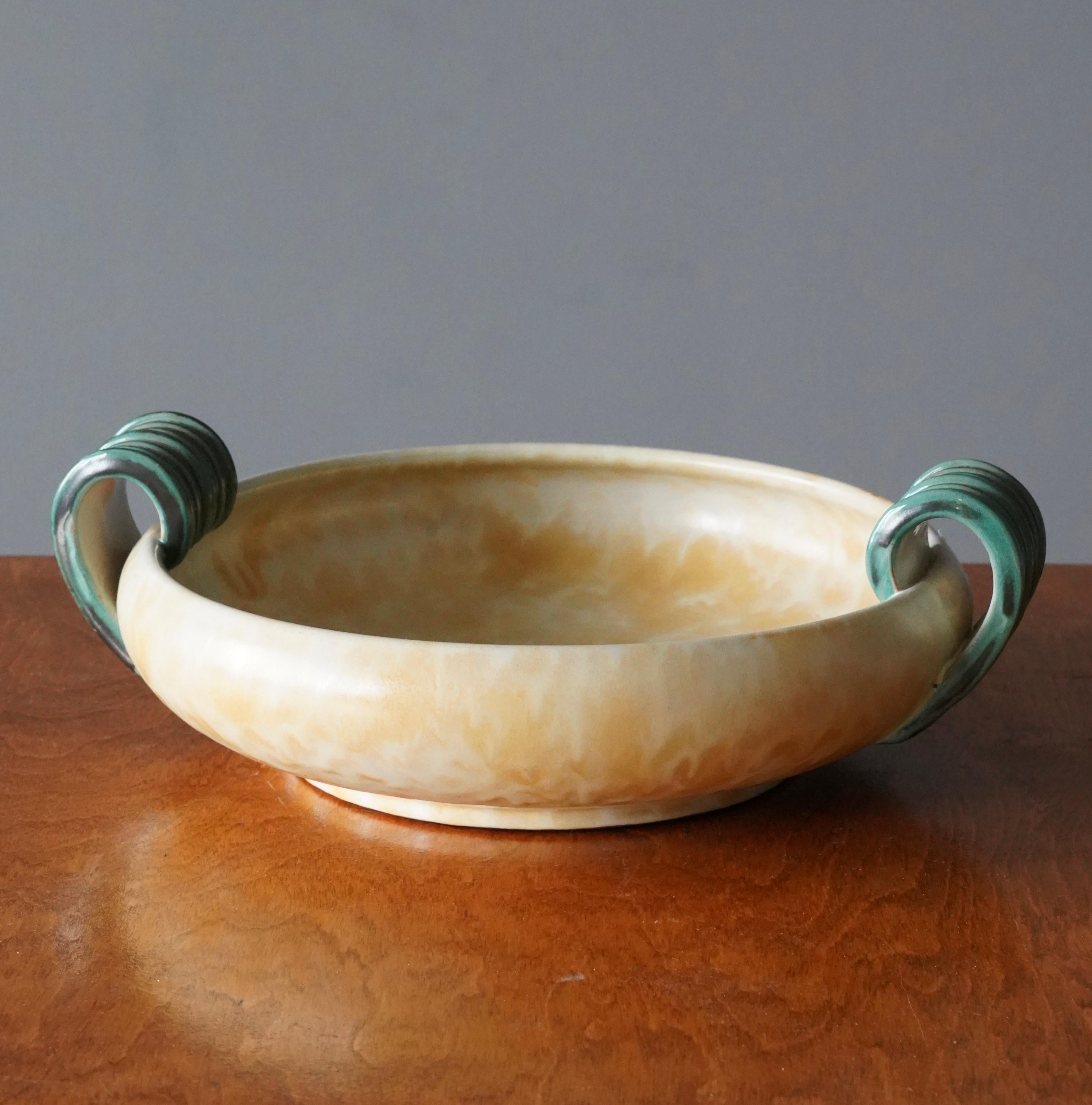 A sizable bowl / dish / vide-poche with handles. Produced by Upsala-Ekeby, Sweden, 1940s. Earthenware.

Other designers of the period include Ettore Sottsass, Carl Harry Stålhane, Lisa Larsson, Axel Salto, and Arne Bang.