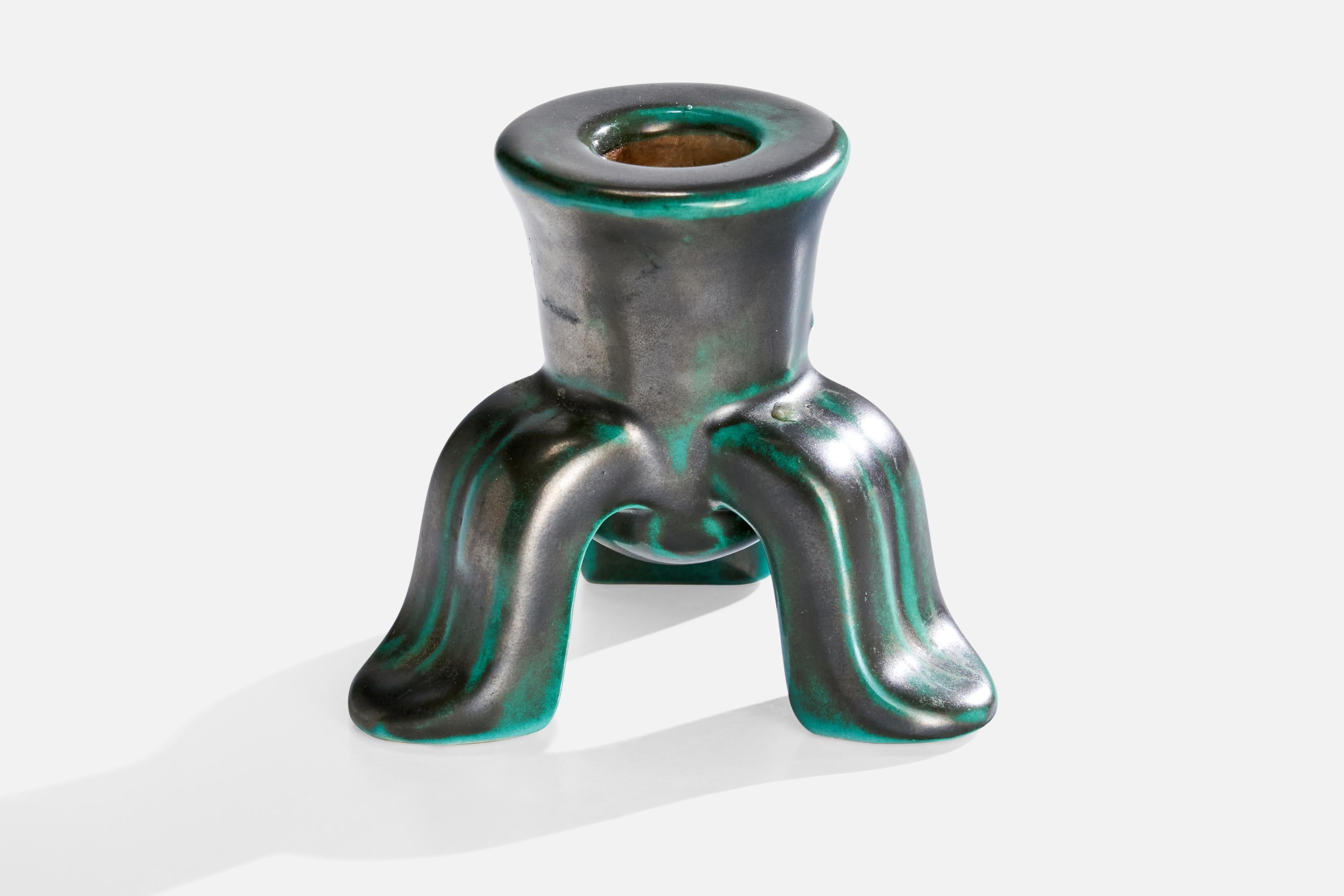 An green-glazed earthenware candlestick designed and produced by Upsala Ekeby, Sweden, 1930s.

Dimensions: 3” H x 3.5” diameter

Holds .75” diameter candles