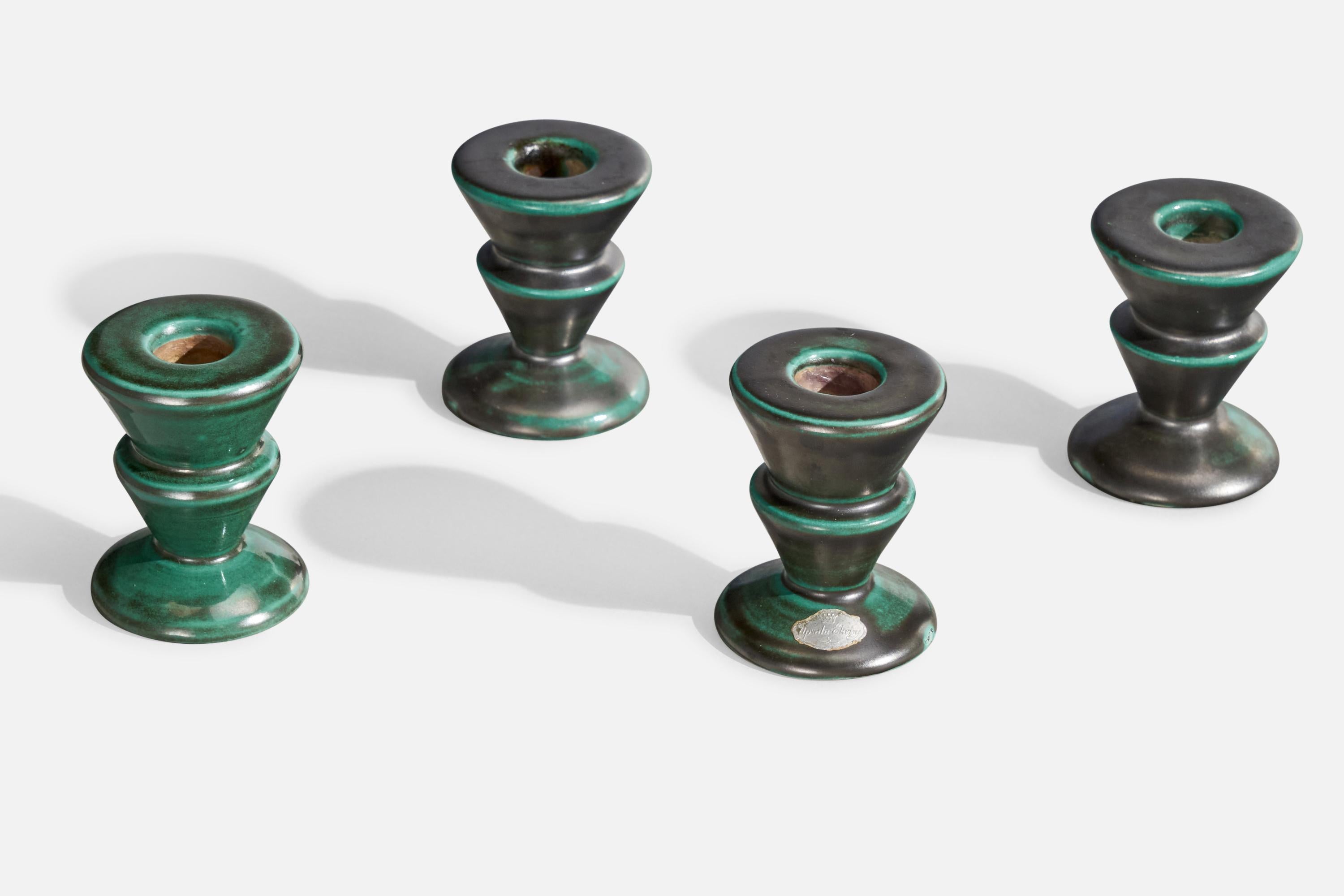 A set of four green-glazed earthenware candlesticks designed and produced by Upsala Ekeby, Sweden, 1930s.

.90 candles
