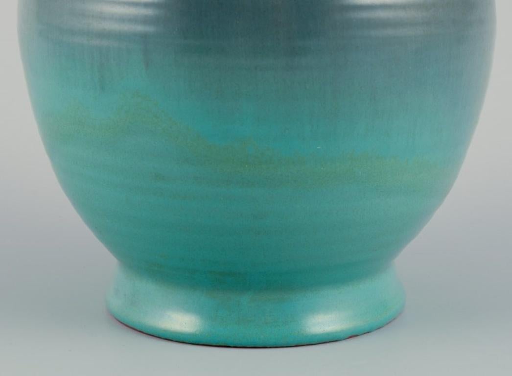 Mid-20th Century Upsala Ekeby ceramic vase with two handles. Glaze in greenish tones. For Sale