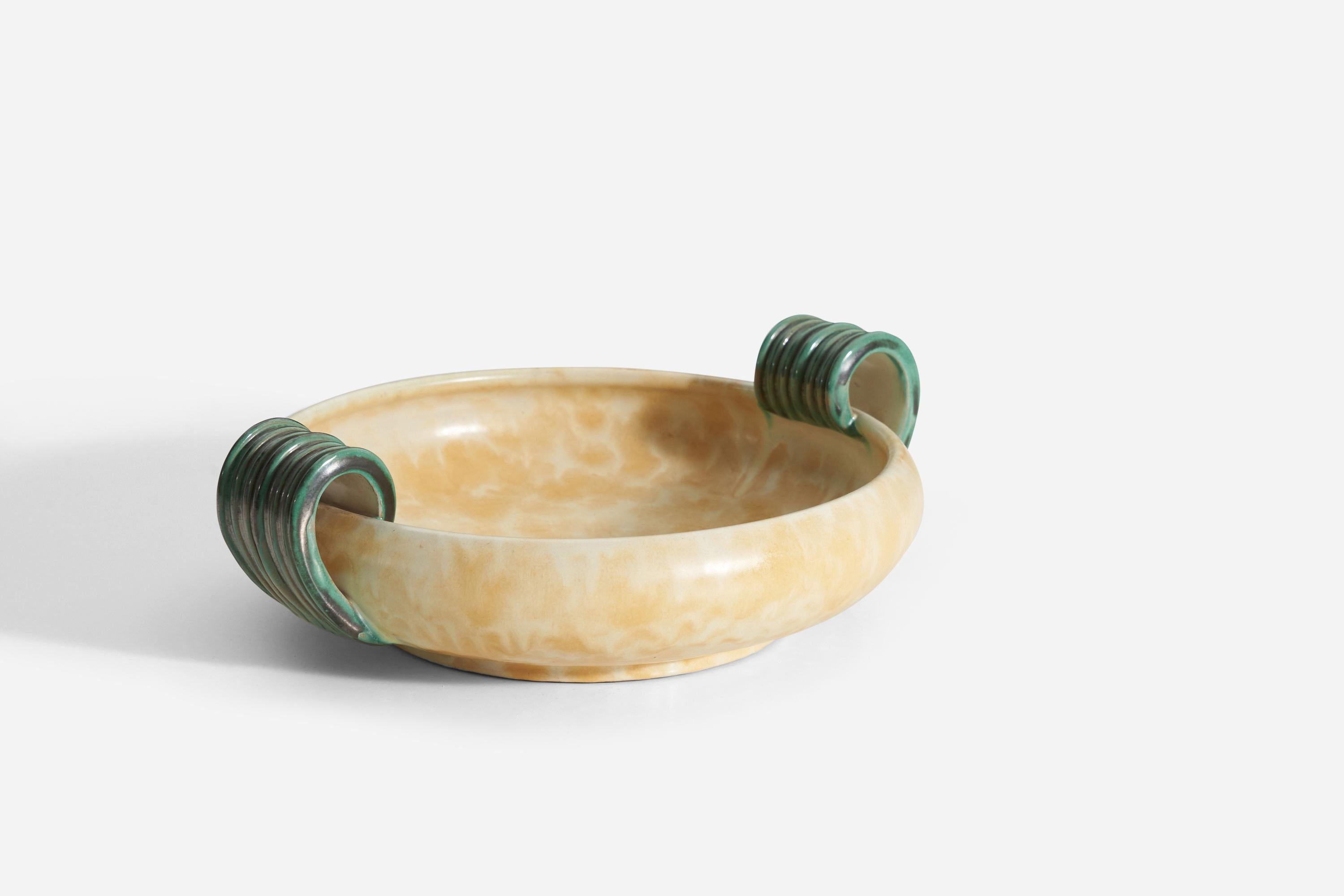 A yellow glazed earthenware decorative dish / bowl / vide-poche with green handles, produced by Upsala-Ekeby, Sweden, 1940s. 
 
