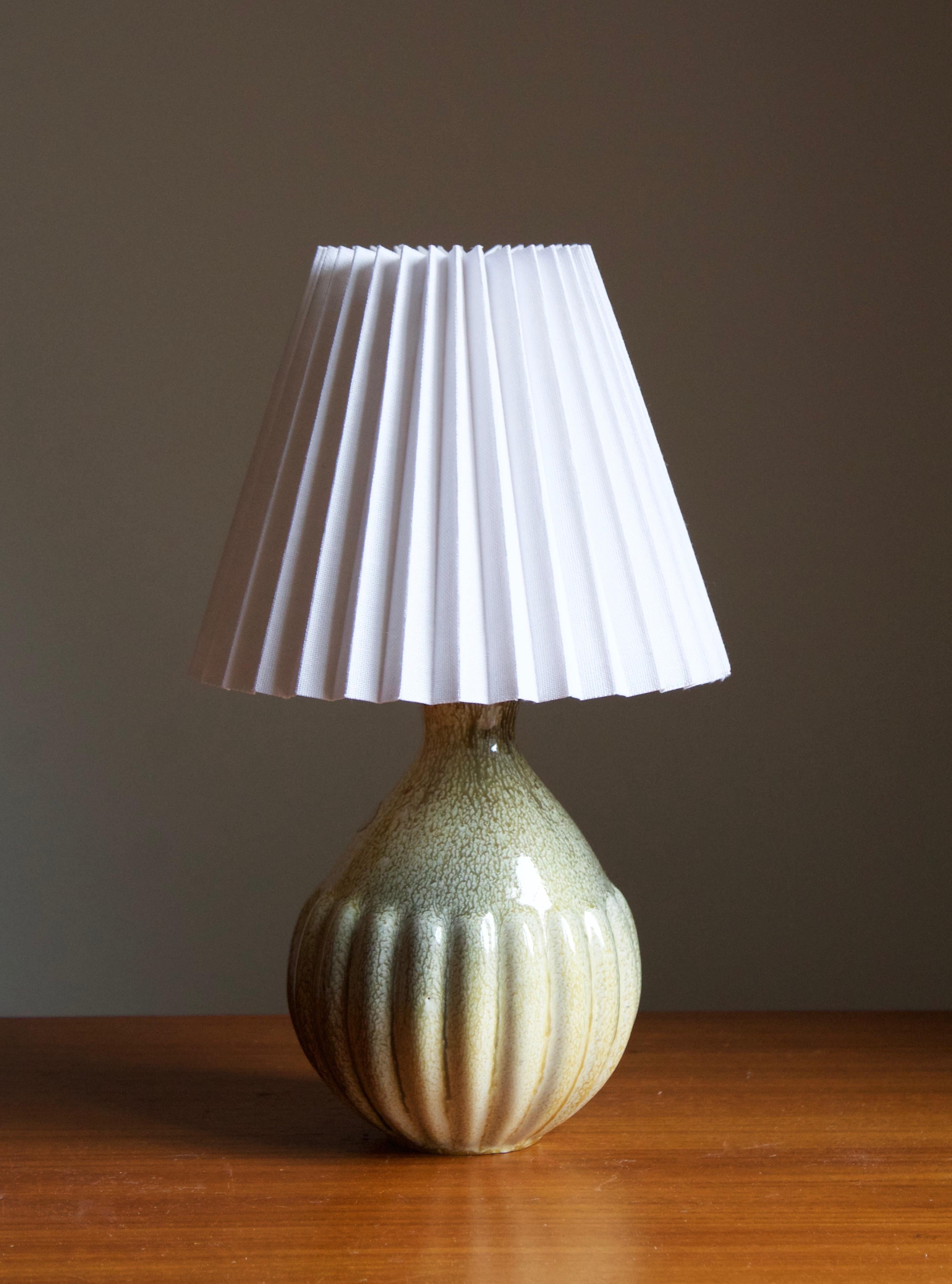 An early modernist table lamp. Produced by Upsala-Ekeby, Sweden, 1930s. Makers label.

Stated dimensions exclude lampshade. Height includes socket. The lampshade can be included in purchase upon request.

Glaze features brown-green colors.

Other