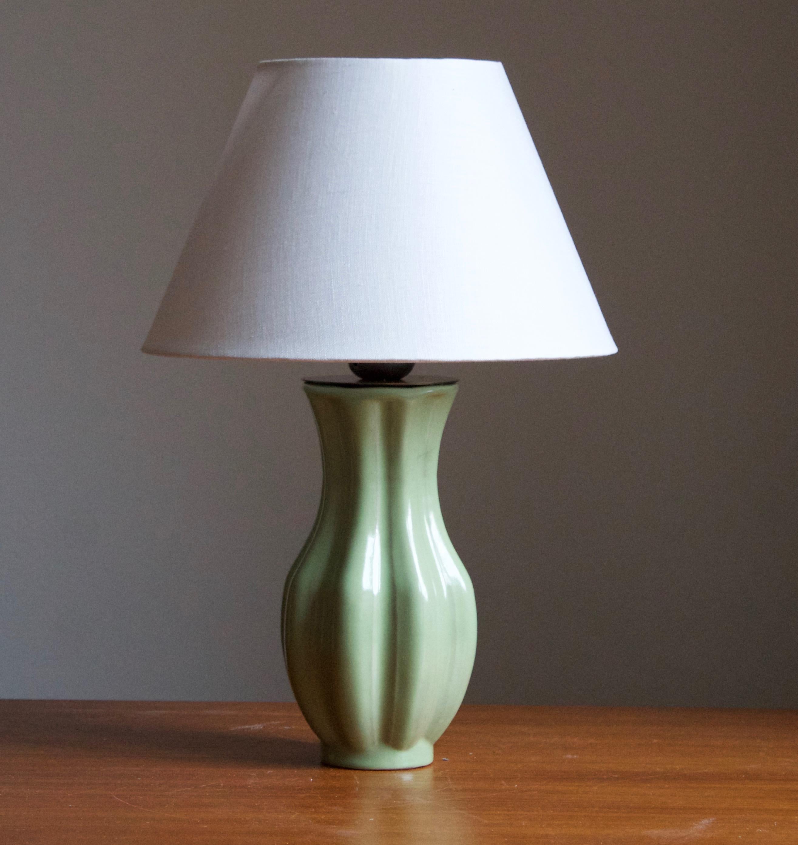 An early modernist table lamp. By Upsala-Ekeby, Sweden, 1930s.

Stated dimensions exclude lampshade. Height includes the socket. Sold without lampshade.

Other designers of the period include Ettore Sottsass, Carl Harry Stålhane, Lisa Larsson,