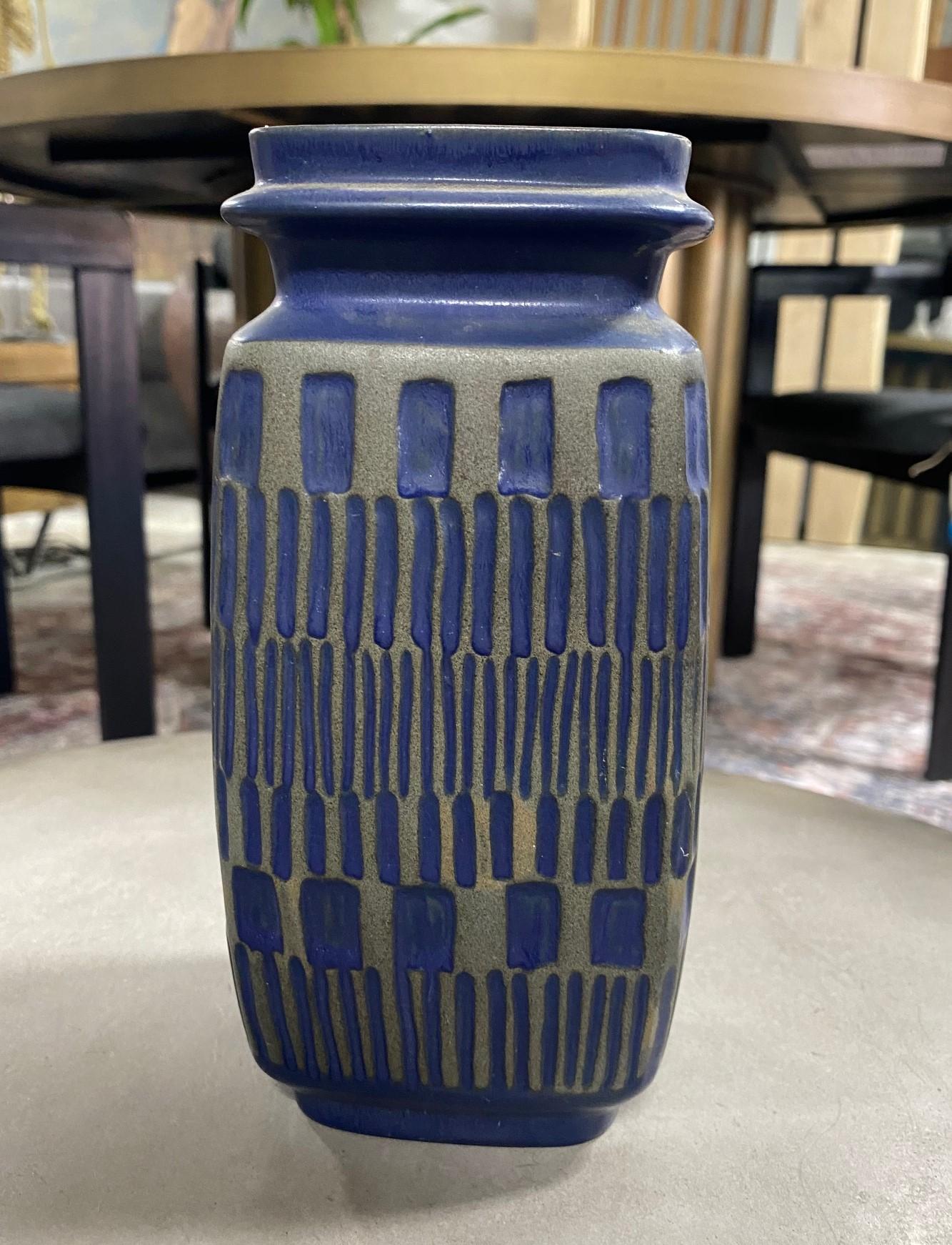 A beautiful Mid-Century Modern vase by Upsala Ekeby Gefle, Sweden featuring a wonderful geometric pattern and penetrating deep blue color (perhaps designed by Hjördis Oldfors who was known for her graphic patterns and striking decor). 

Signed/