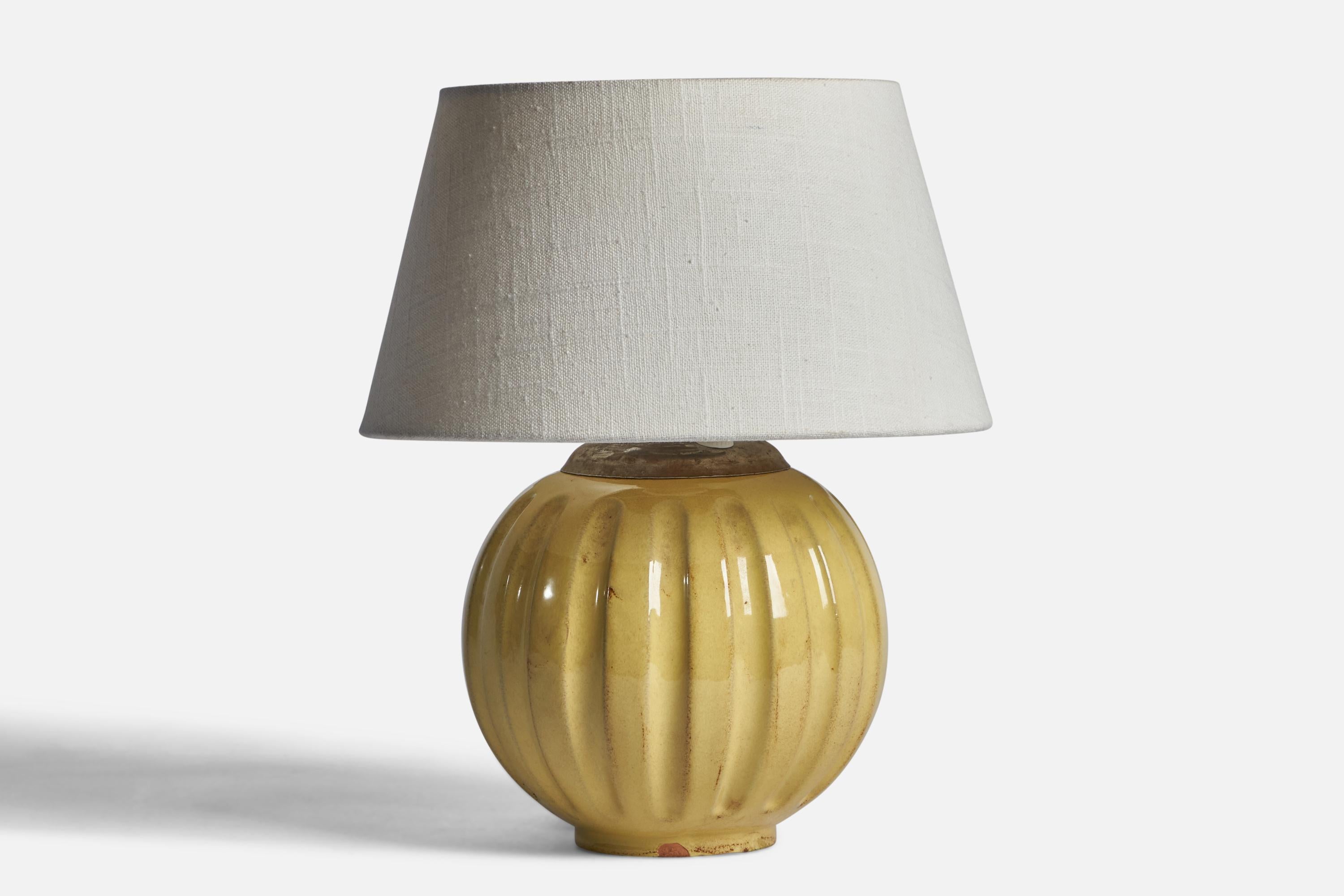 A yellow-glazed fluted earthenware and brass table lamp designed and produced by Upsala Ekeby, Sweden, 1930s.

Dimensions of Lamp (inches): 9.25” H x 7” Diameter
Dimensions of Shade (inches): 7” Top Diameter x 10” Bottom Diameter x 5.5” H