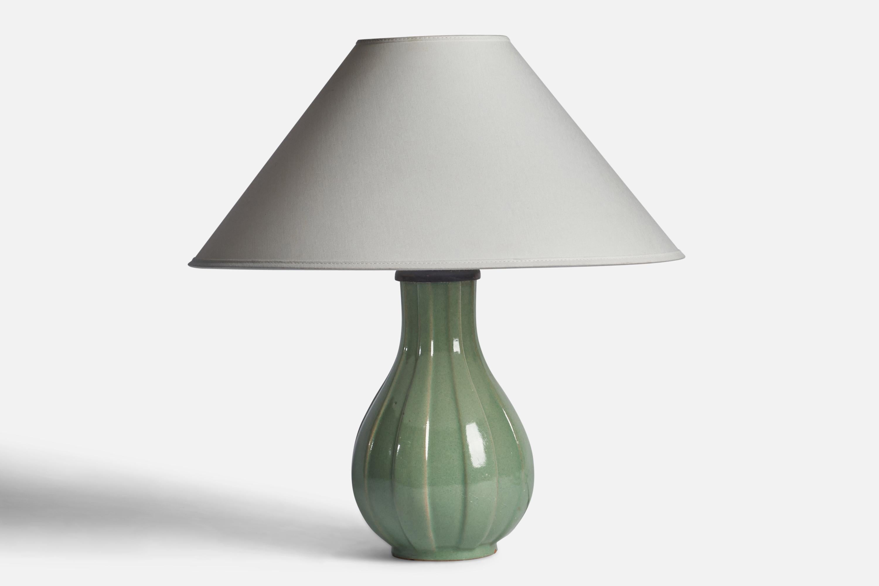 A green-glazed earthenware table lamp designed and produced by Upsala Ekeby, Sweden, 1930s.

“L” stamp on bottom

Dimensions of Lamp (inches): 12” H x 6.25” Diameter
Dimensions of Shade (inches): 4.5” Top Diameter x 16” Bottom Diameter x 9”