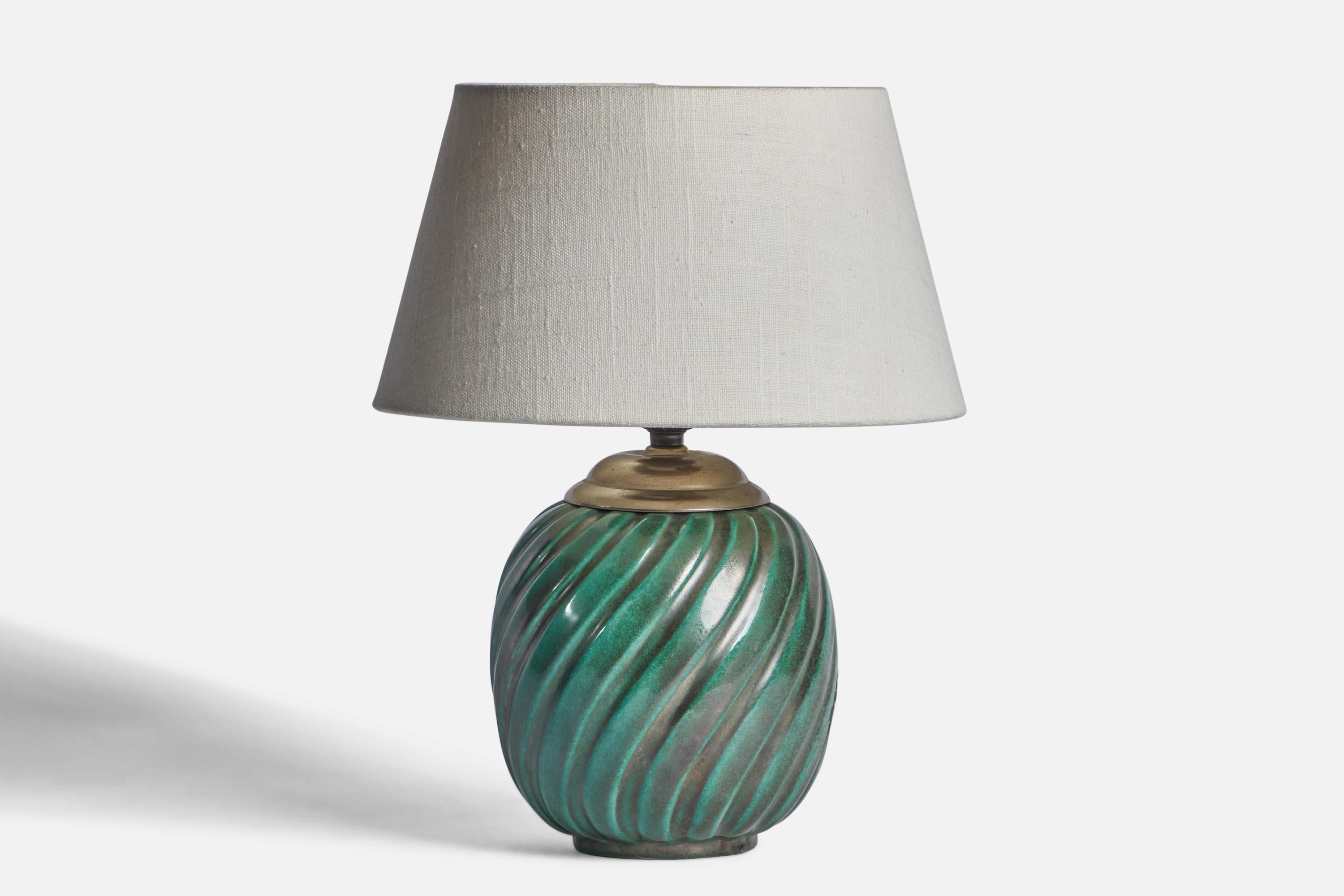 A green-glazed fluted earthenware and brass table lamp designed and produced by Upsala Ekeby, Sweden, 1930s.

Dimensions of Lamp (inches): 10” H x 5.75” Diameter
Dimensions of Shade (inches): 7” Top Diameter x 10” Bottom Diameter x