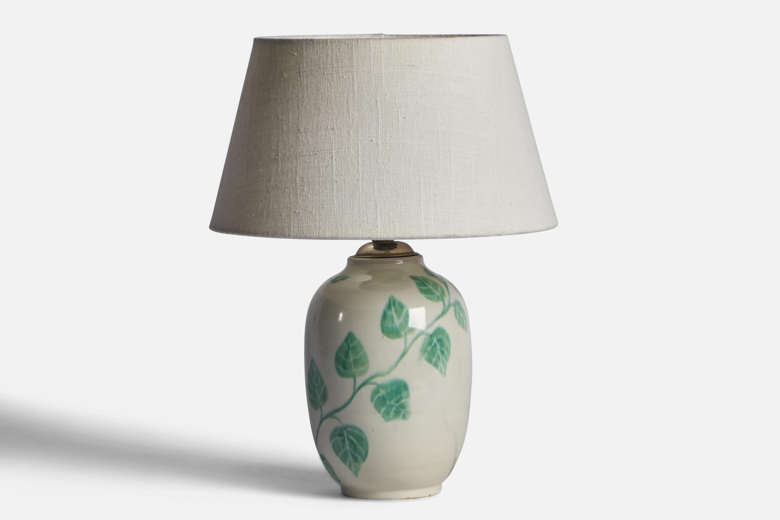 A hand-painted green and white-glazed earthenware table lamp designed and produced by Upsala Ekeby, Sweden, 1930s.

Dimensions of Lamp (inches): 10” H x 4.60” Diameter
Dimensions of Shade (inches): 7” Top Diameter x 10” Bottom Diameter x