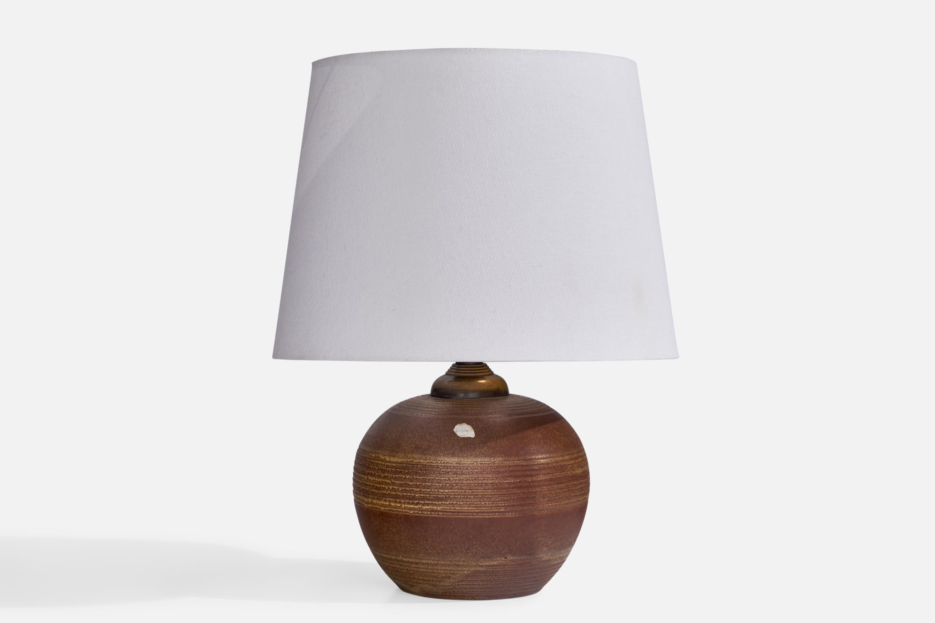 A brown-glazed earthenware and brass table lamp designed and produced by Upsala Ekeby, Sweden, 1930s.

Dimensions of Lamp (inches): 8.25” H x 5.5” Diameter
Dimensions of Shade (inches): 8” Top Diameter x 10” Bottom Diameter x 7.25” H
Dimensions of
