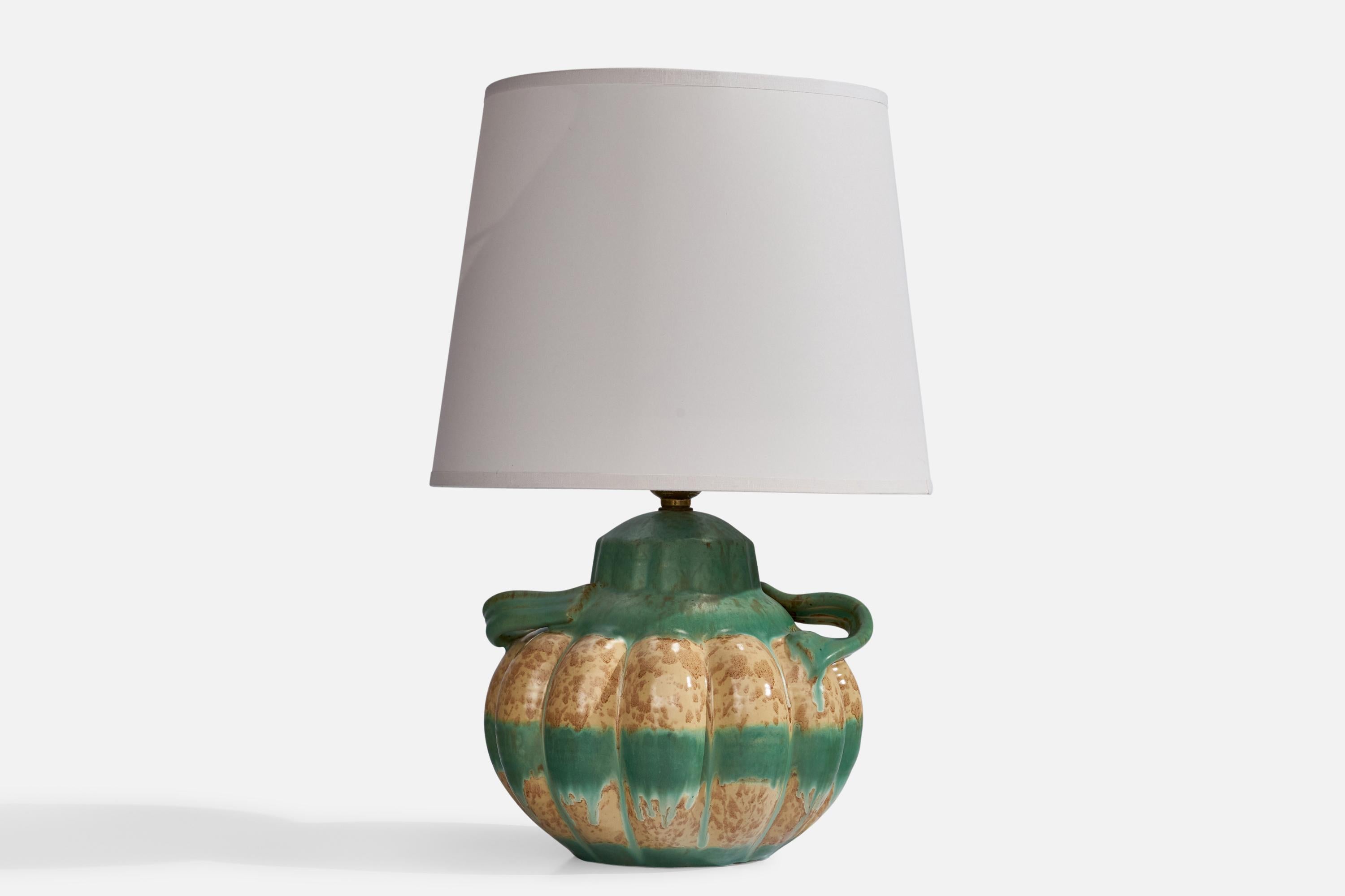 A green and beige-glazed earthenware table lamp designed and produced by Upsala Ekeby, Sweden, 1930s.'

Dimensions of Lamp (inches): 9.8” H x 8” W x 7” Depth
Dimensions of Shade (inches): 8” Top Diameter x 10” Bottom Diameter x 8” H
Dimensions of