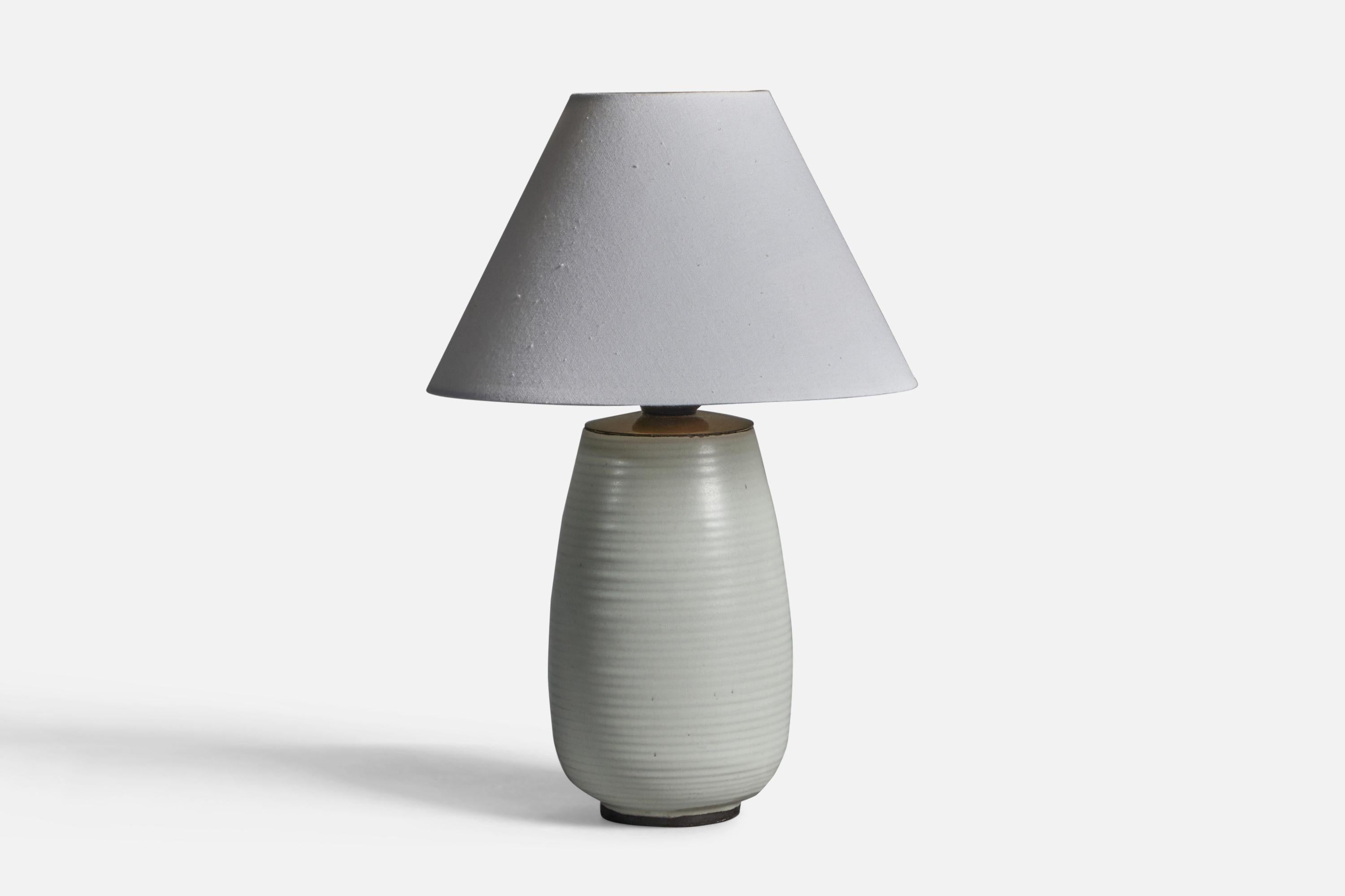 A white-glazed earthenware and brass table lamp, designed and produced by Upsala Ekeby, Sweden, 1940s.

Dimensions of Lamp (inches): 8.75